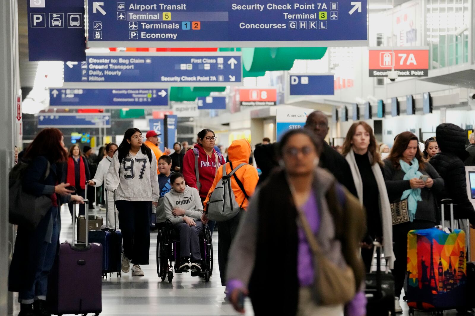 Travelers walk through Terminal 3 at O'Hare International Airport in Chicago, Tuesday, Nov. 26, 2024. (AP Photo/Nam Y. Huh)