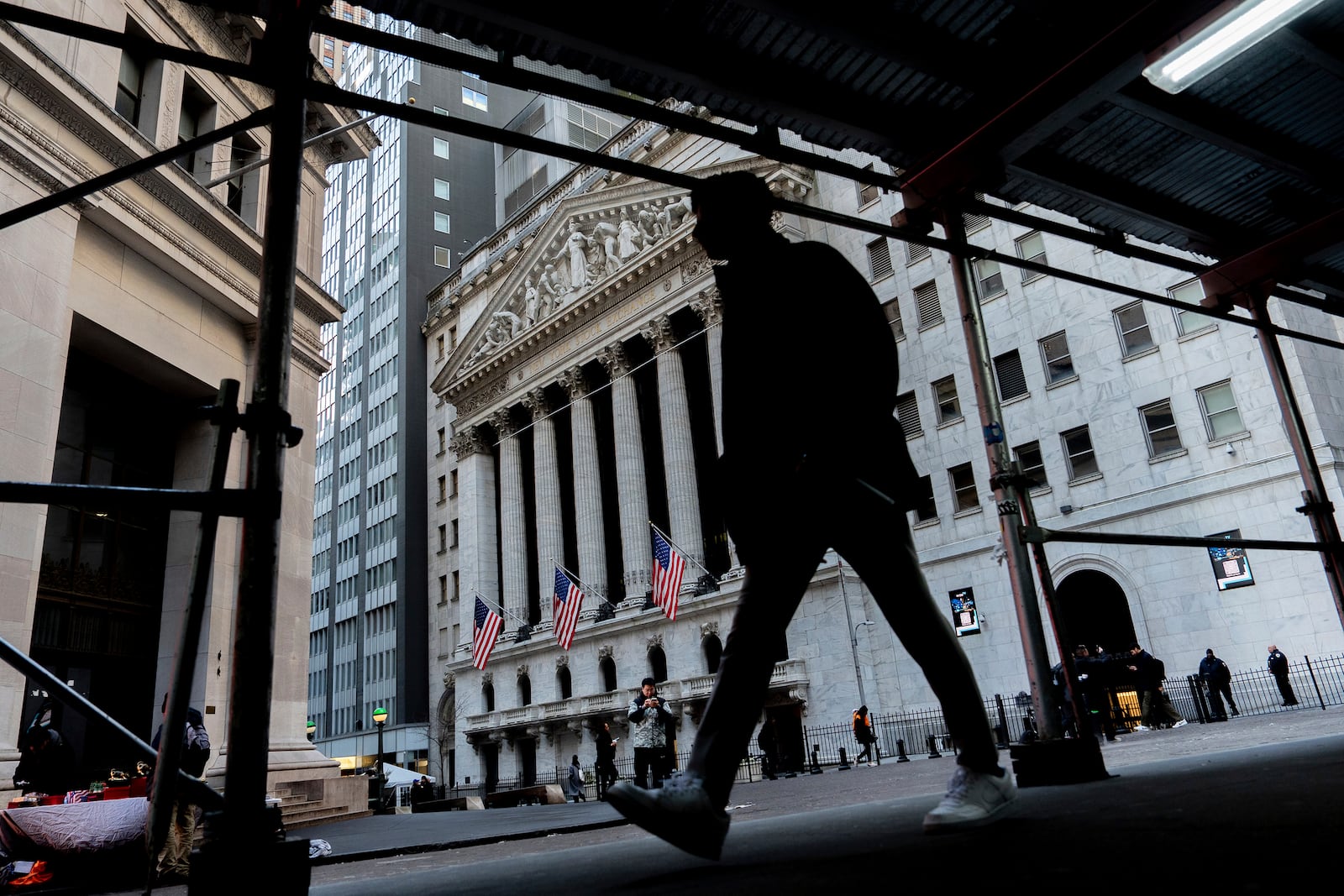 People walk past the New York Stock Exchange, Tuesday, Jan. 28, 2025, in New York. (AP Photo/Julia Demaree Nikhinson)