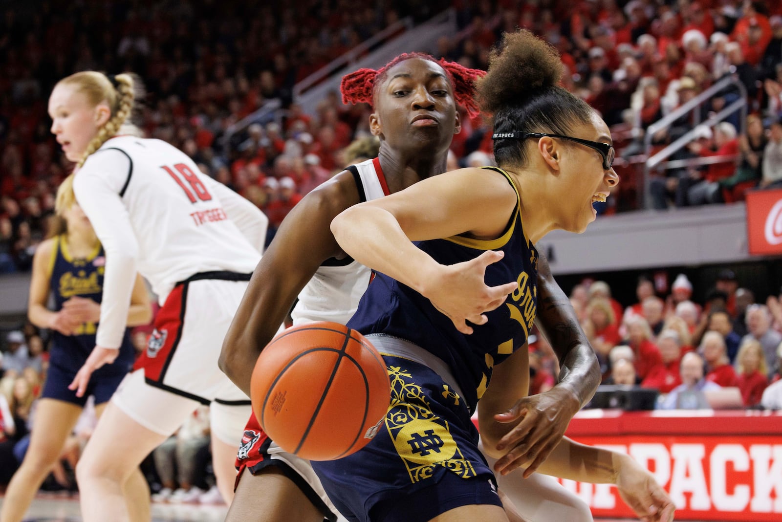 Notre Dame's Olivia Miles (5) loses the ball to NC State's Saniya Rivers, left, during the first half of an NCAA college basketball game in Raleigh, N.C., Sunday, Feb. 23, 2025. (AP Photo/Ben McKeown)