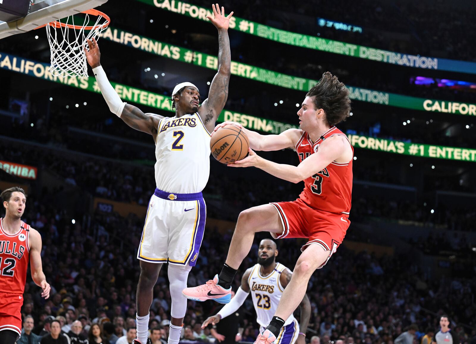 Chicago Bulls guard Josh Giddey (3) gets a pass off against Los Angeles Lakers forward Jarred Vanderbilt (2) in the first half of an NBA basketball game Saturday, March 22, 2025, in Los Angeles. (AP Photo/Wally Skalij)