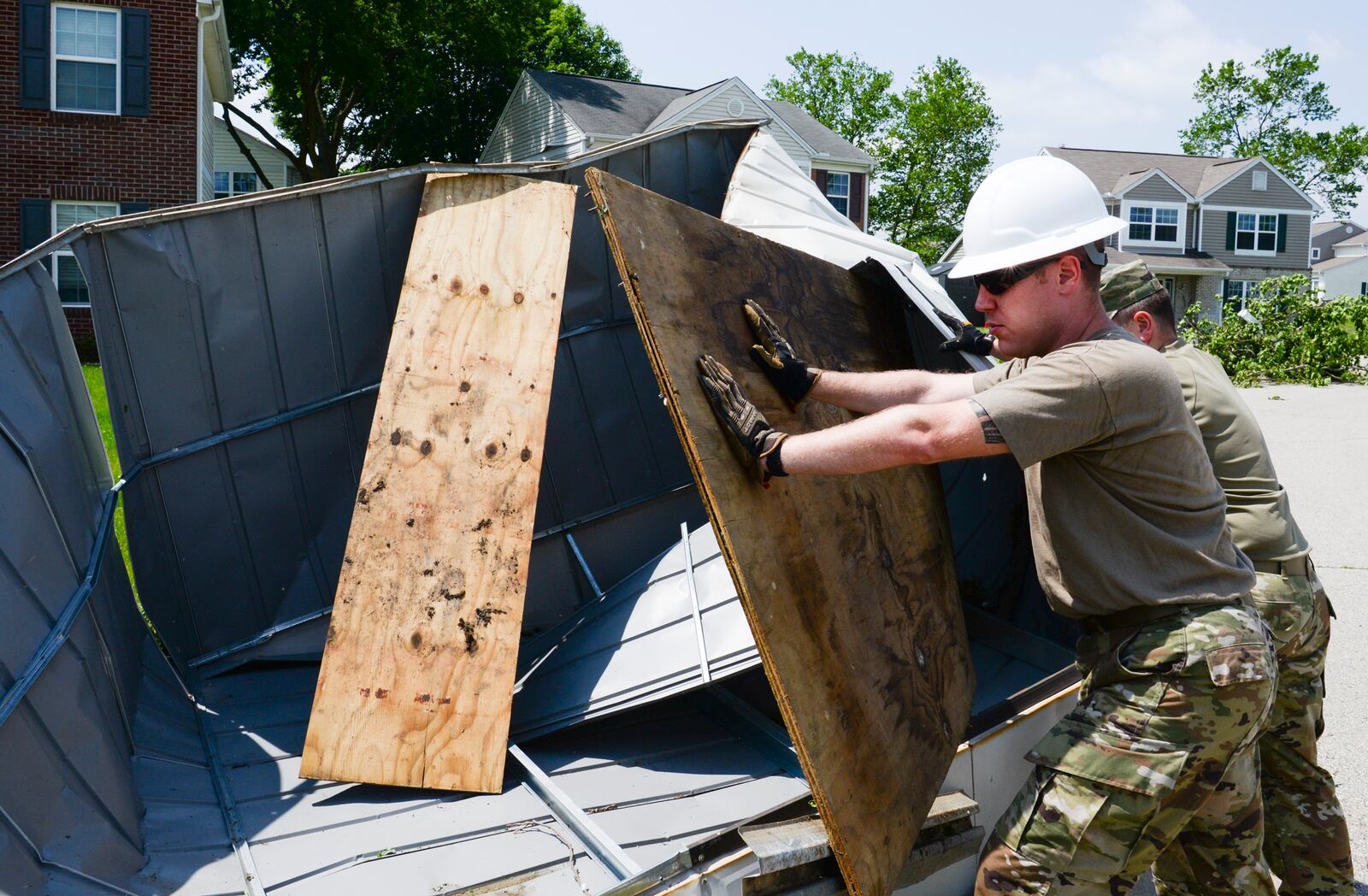 Staff Sgt. Michael Olson, National Air and Space Intelligence Center, helps to remove a shed from the front yard of someone’s home during recovery operations. Residents worked alongside other volunteers from around Wright-Patterson AFB and base emergency responders to ensure everyone’s safety and begin the cleanup process. (U.S. Air Force photo by R.J. Oriez)