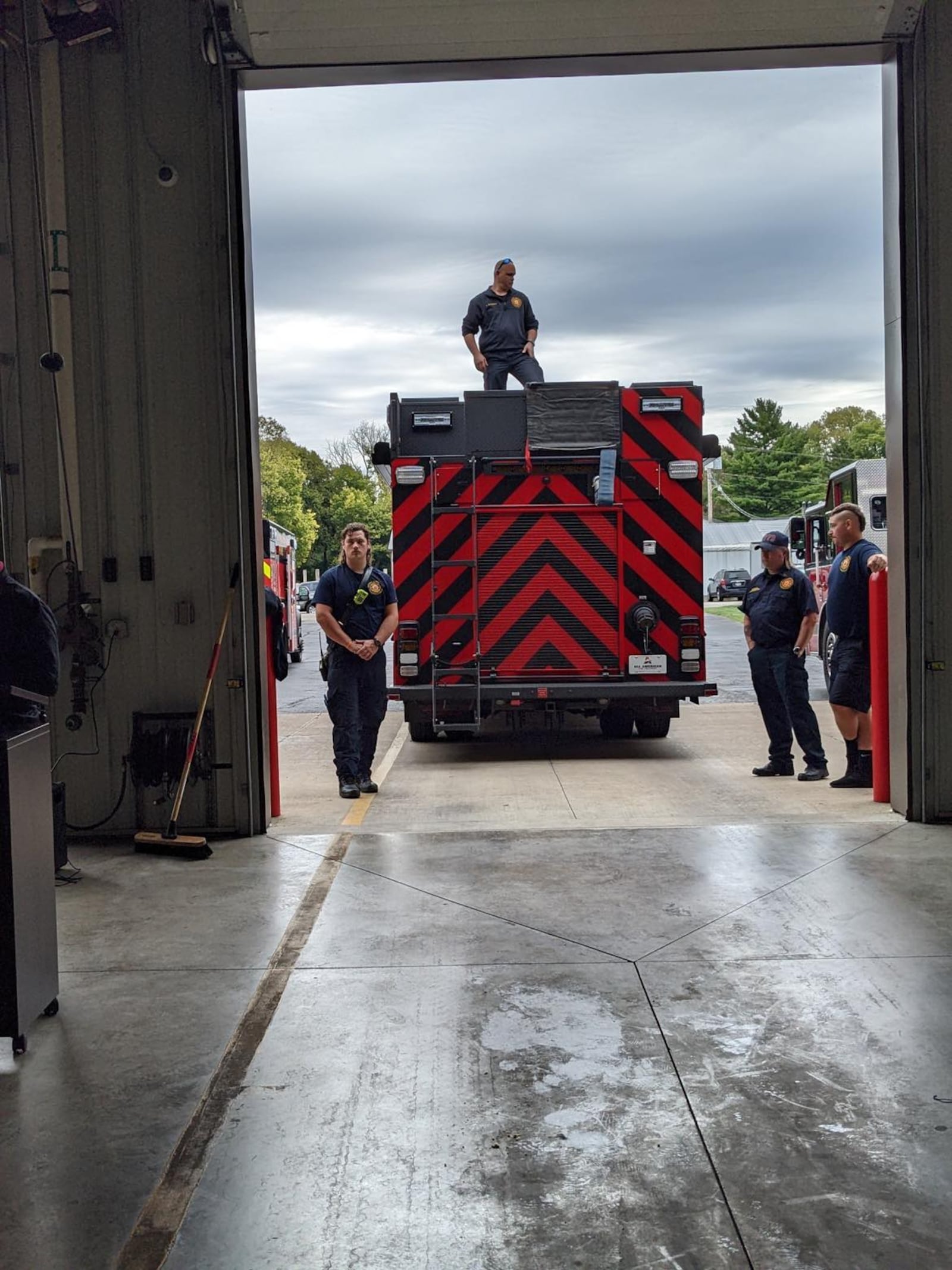 Bethel Township firefighters and officials prepare to push in the newest vehicle in the fleet, one that can do multiple jobs. Photo by Nancy Brown.