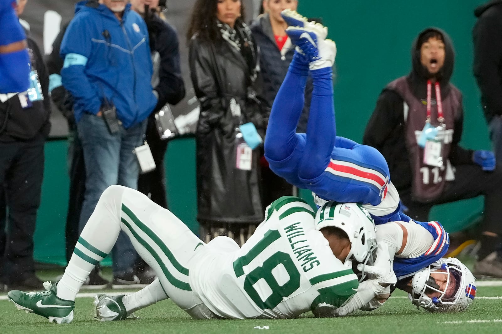 Buffalo Bills cornerback Taron Johnson, right, intercepts a pass intended for New York Jets wide receiver Mike Williams (18) during the second half of an NFL football game in East Rutherford, N.J., Monday, Oct. 14, 2024. (AP Photo/Pamela Smith)