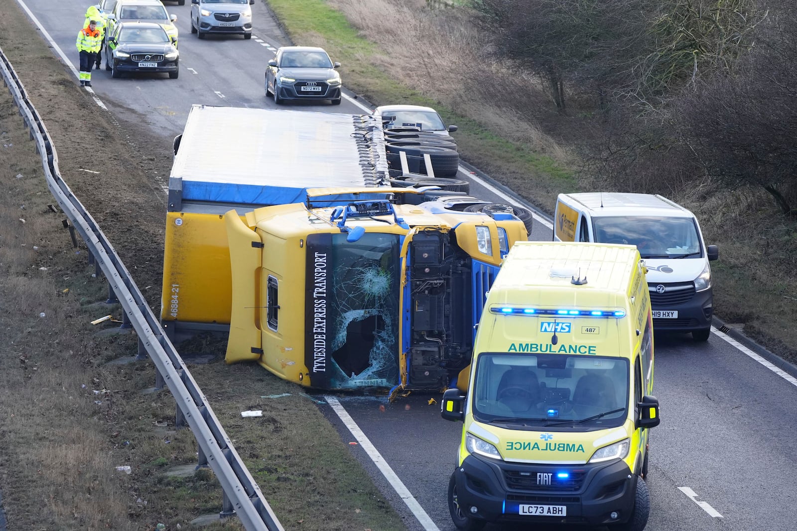 An ambulance attends the scene of a crash during strong winds on the north bound A19 near to the A690 Durham Road, in County Durham, in the North East of England, Friday Jan. 24, 2025, as Storm Eowyn hits the country. (Owen Humphreys/PA via AP)