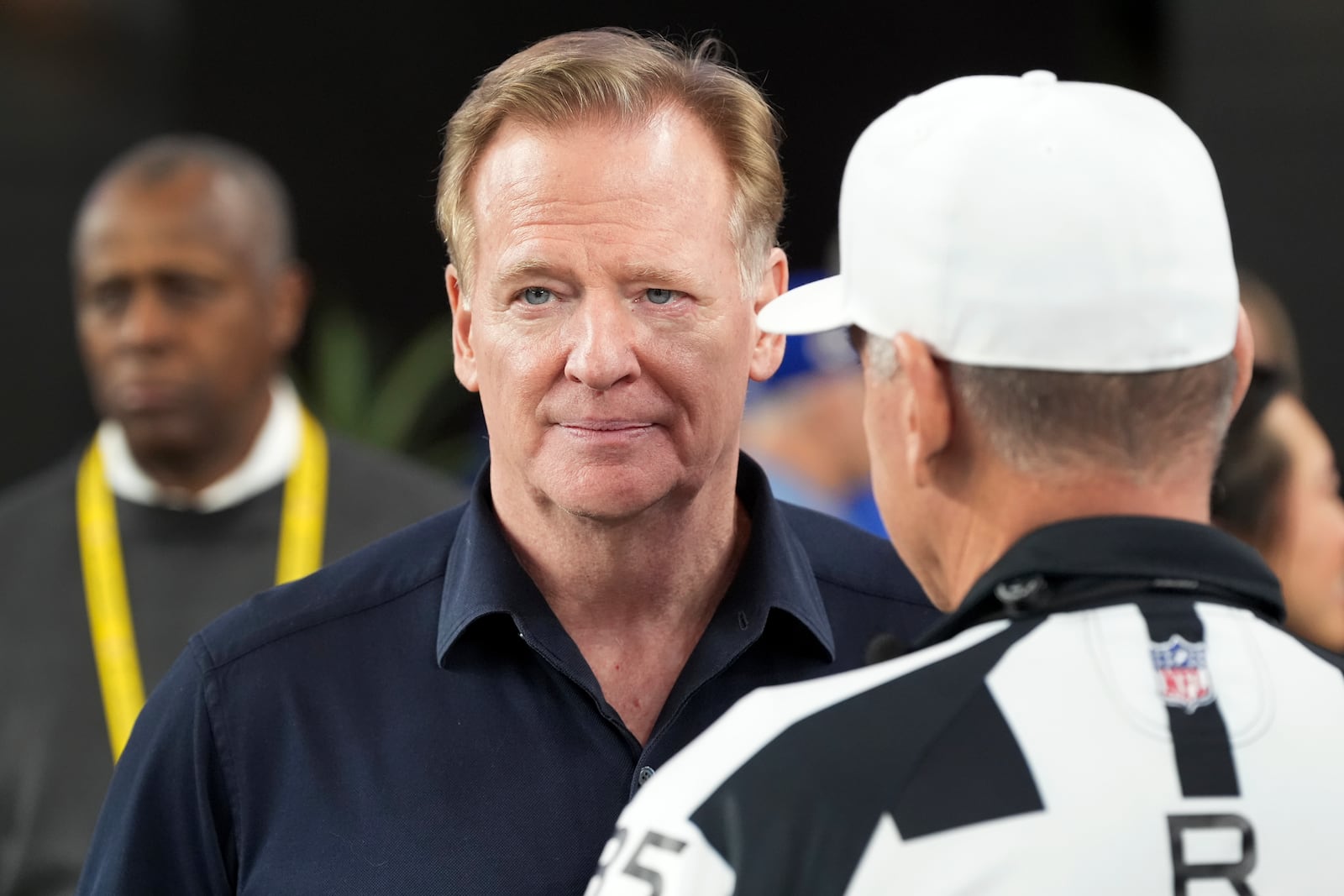 NFL Commissioner Roger Goodell, left, talks with Referee John Hussey before an NFL wild card playoff football game between the Los Angeles Rams and Minnesota Vikings, Monday, Jan. 13, 2025, in Glendale, Ariz. (AP Photo/Ross D. Franklin)