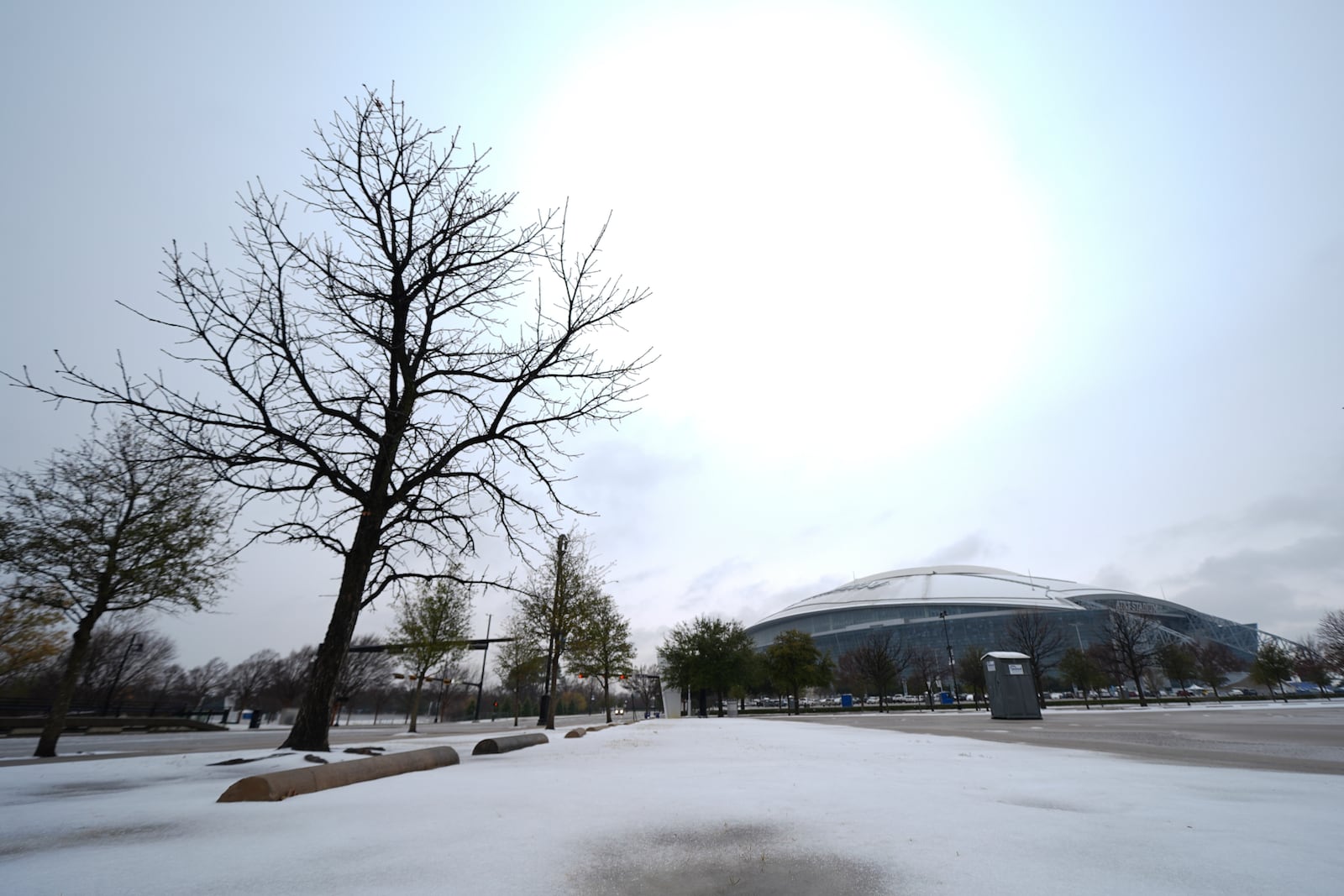 Snow is accumulated on a parking lot near AT&T Stadium a day prior to the Cotton Bowl NCAA College Football Playoff semifinal game between Ohio State and Texas, Thursday, Jan. 9, 2025, in Arlington, Texas. (AP Photo/Julio Cortez)