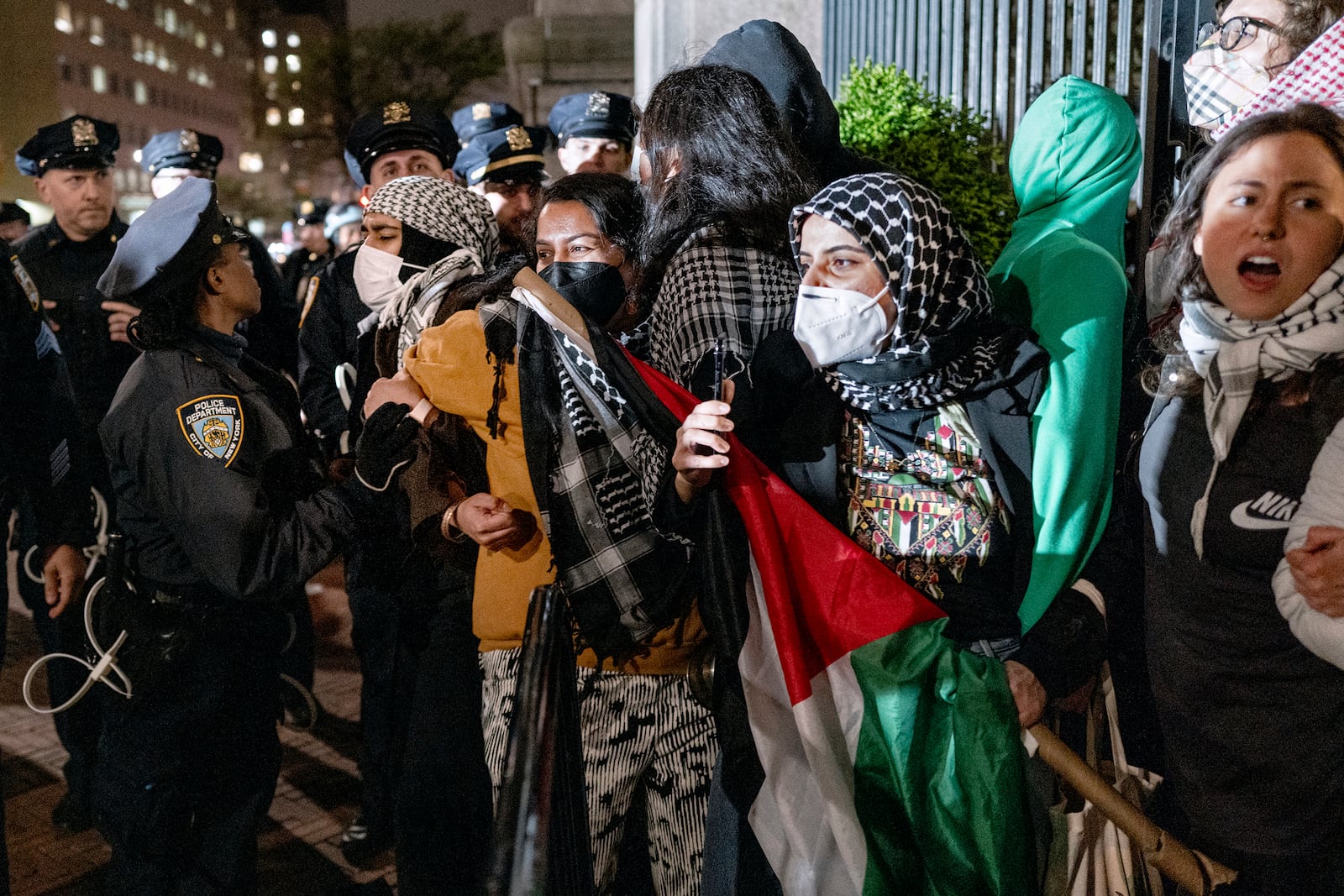 FILE - Demonstrators hold their ground near a main gate at Columbia University in New York, Tuesday, April 30, 2024, as New York City police officers move to clear the area after a building was taken over by pro-Palestinian protesters earlier in the day. (AP Photo/Craig Ruttle, File)