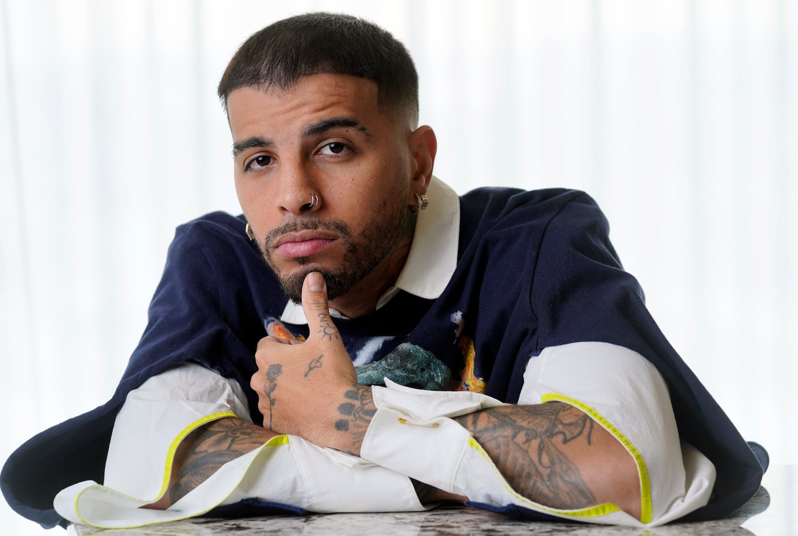 FILE - Singer/rapper Rauw Alejandro poses for a portrait at the Aria Hotel in Las Vegas on Nov. 18, 2021. (AP Photo/Chris Pizzello, File)