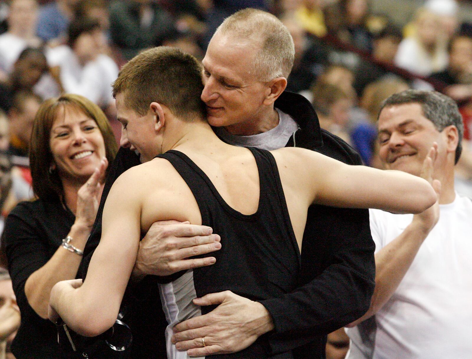 David Taylor of Graham is congratulated by his family after defeating Manuel Cintron of Alliance at 135 lbs. to become a four-time Ohio state wrestling champion Saturday, March 7, 2009, at the Schottenstein Center in Columbus.
Staff Photo by Barbara J. Perenic