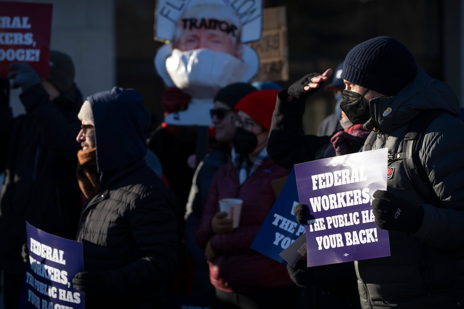 Demonstrators rally in support of federal workers outside of the Department of Health and Human Services, Friday, Feb. 14, 2025, in Washington. (AP Photo/Mark Schiefelbein)