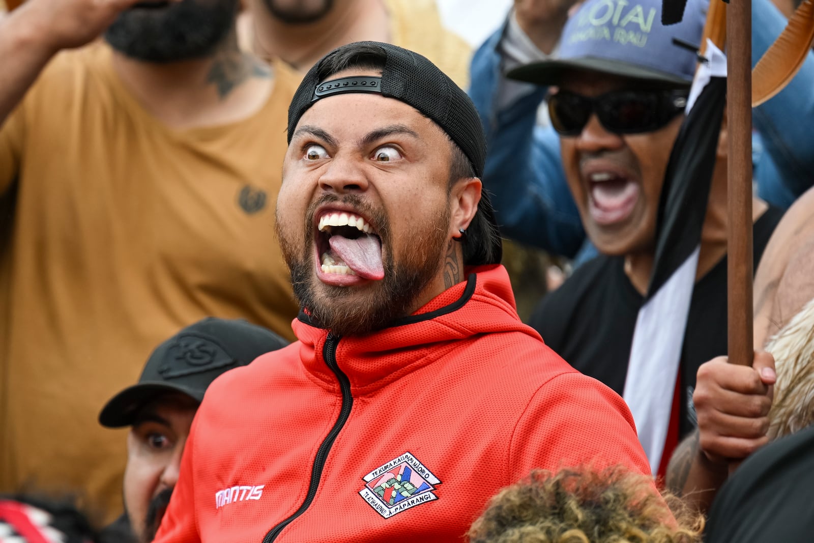 A protester reacts outside New Zealand's parliament during a demonstration against a proposed law that would redefine the country's founding agreement between Indigenous Māori and the British Crown, in Wellington Tuesday, Nov. 19, 2024. (AP Photo/Mark Tantrum)