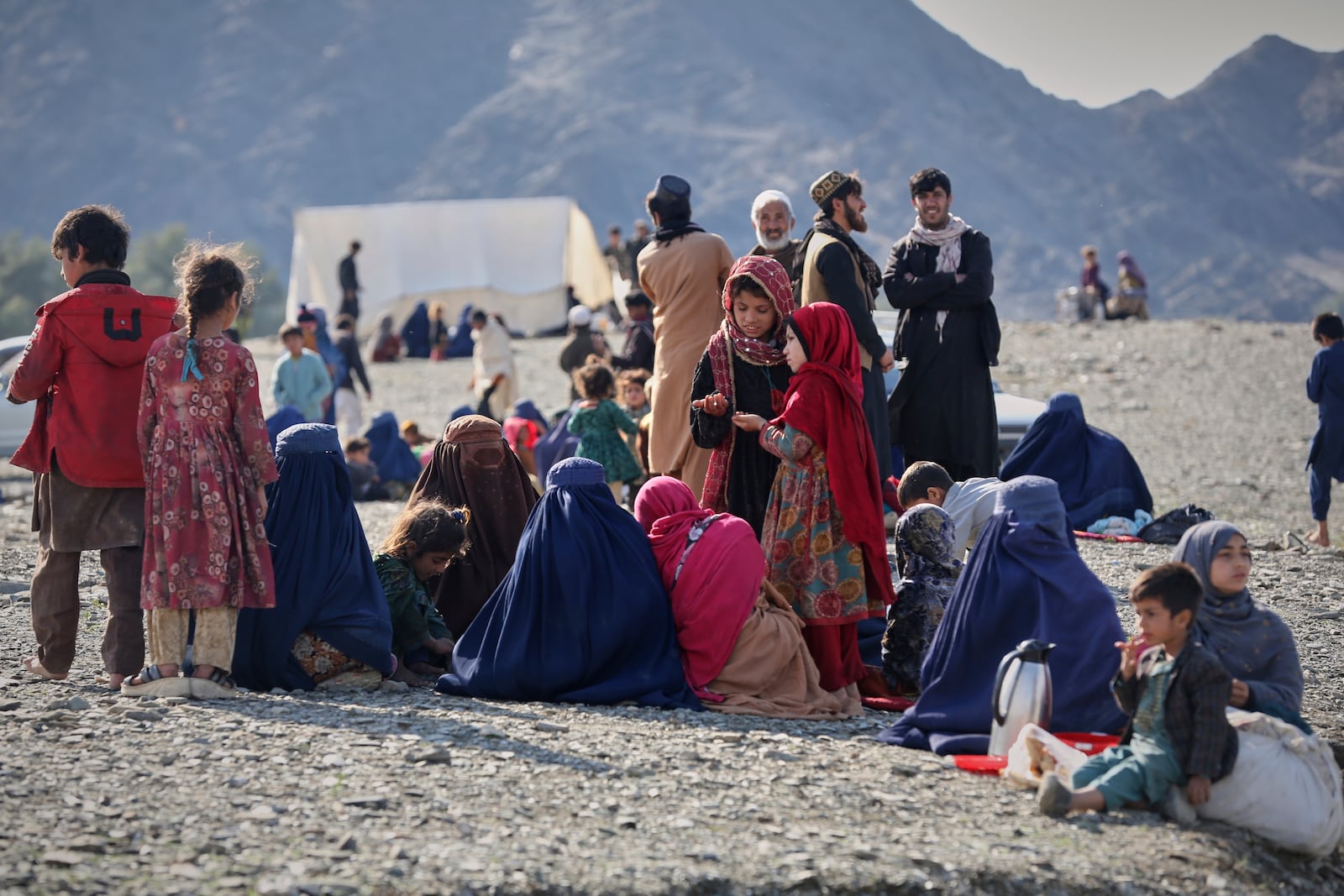 Afghans wait to cross the closed Torkham border with Pakistan, where Pakistani and Afghan forces exchanged fire overnight, in Torkham, Afghanistan, Monday, March 3, 2025.(AP Photo/Shafiullah Kakar)