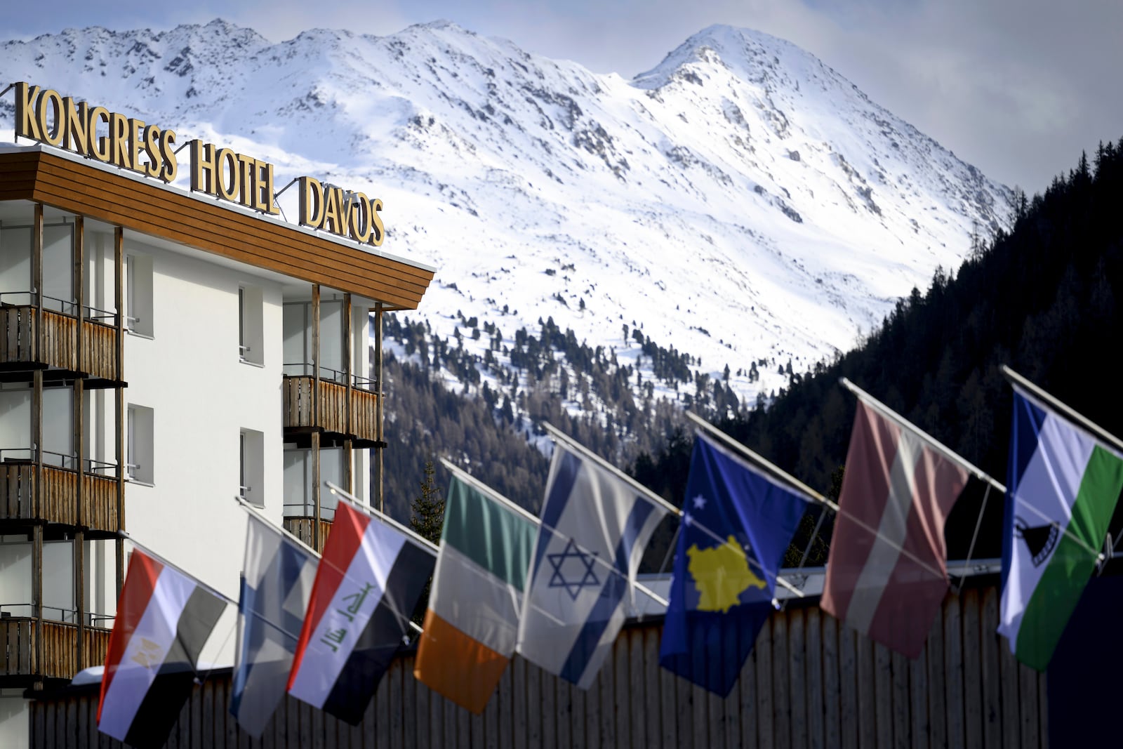 Countries' flags fly on the roof of the congress center in front of Kongress Hotel prior to the 55th annual meeting of the World Economic Forum, WEF, in Davos, Switzerland, Monday, Jan. 20, 2025. (Laurent Gillieron/Keystone via AP)