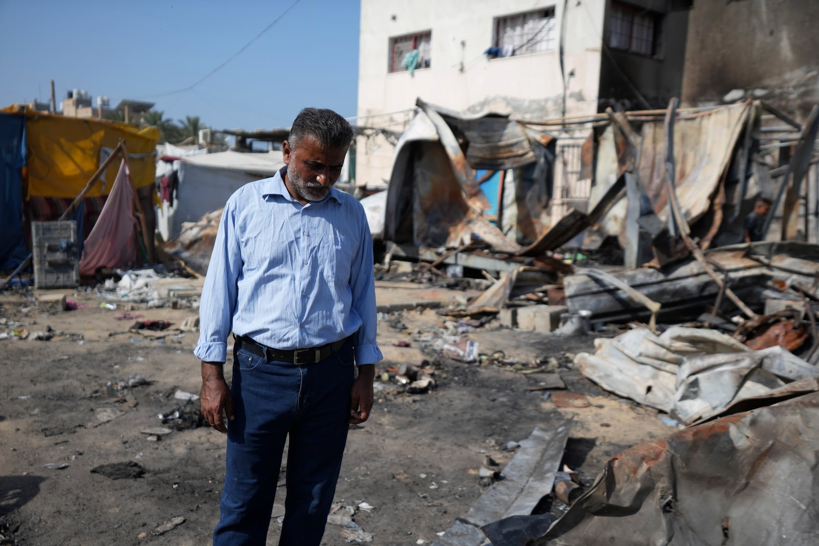 Abdel-Hayy Shaban al-Dalu, at the site where his nephew, Shaban, was killed in a fire after an Israeli strike hit a tent area in the courtyard of Al Aqsa Martyrs hospital in Deir al-Balah, Gaza Strip, Wednesday, Oct. 16, 2024. (AP Photo/Abdel Kareem Hana)