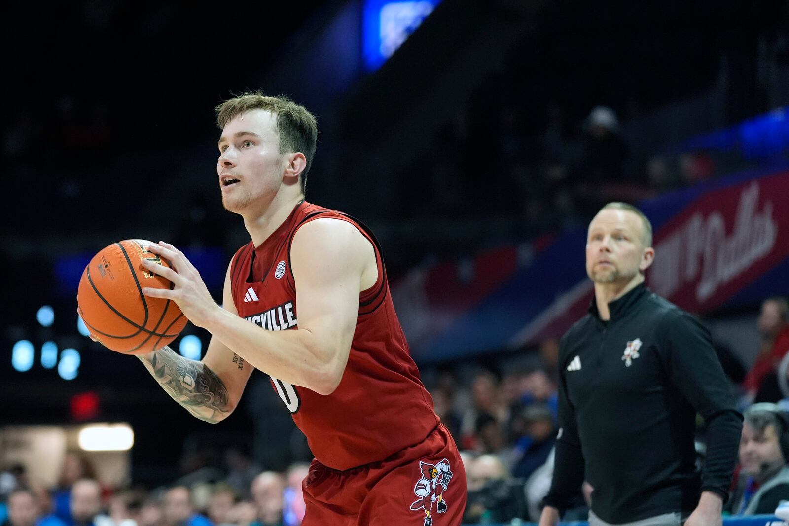 Louisville guard Reyne Smith (6) lines up to shoot as head coach Pat Kelsey looks on during the second half of an NCAA college basketball game against SMU, Tuesday, Jan. 21, 2025, in Dallas. (AP Photo/LM Otero)