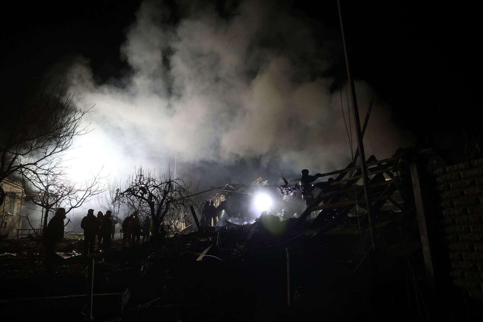 Rescuers work on site of a residential building destroyed by a Russian drone strike in Zaporizhzhia, Ukraine, Friday, March 21, 2024. (AP Photo/Kateryna Klochko)