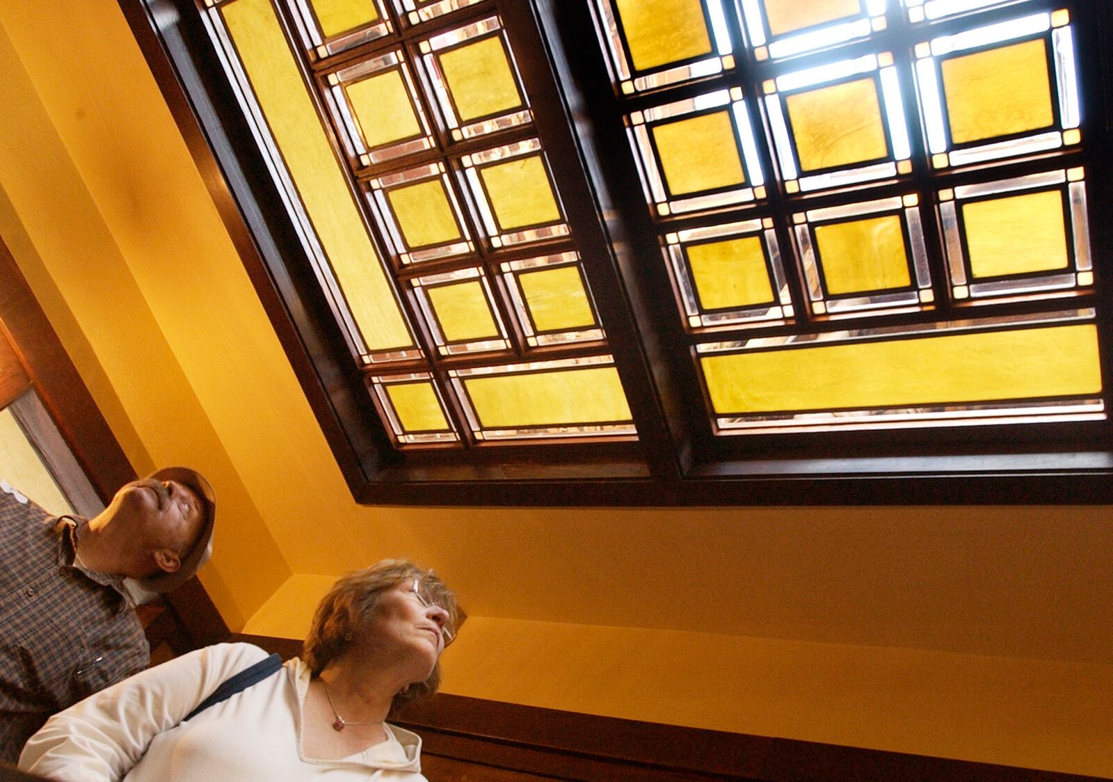 Tom and Reggie Wolfel from Columbus look up at the stained glass window in the ceiling during the tours on the first day open to the public at the Westcott House in this October 2005 file photo from the News-Sun archives.