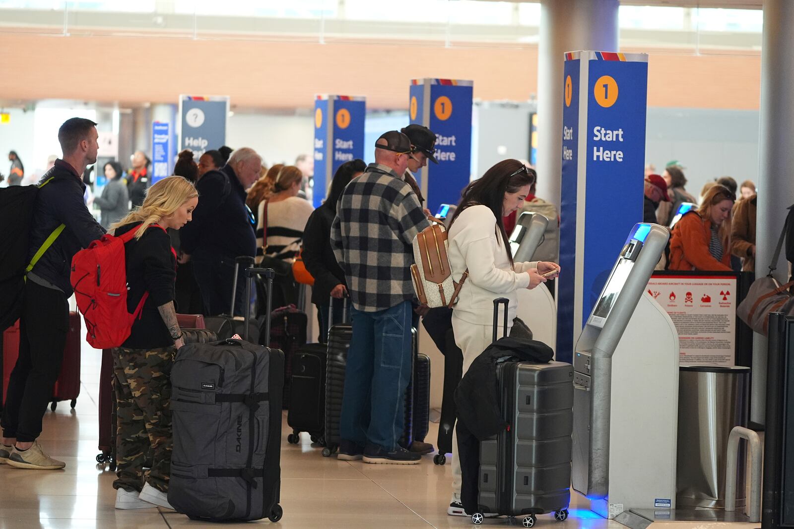 Travellers use kiosks to check in for flights on Southwest Airlines in Denver International Airport Tuesday, Nov. 26, 2024, in Denver. (AP Photo/David Zalubowski)