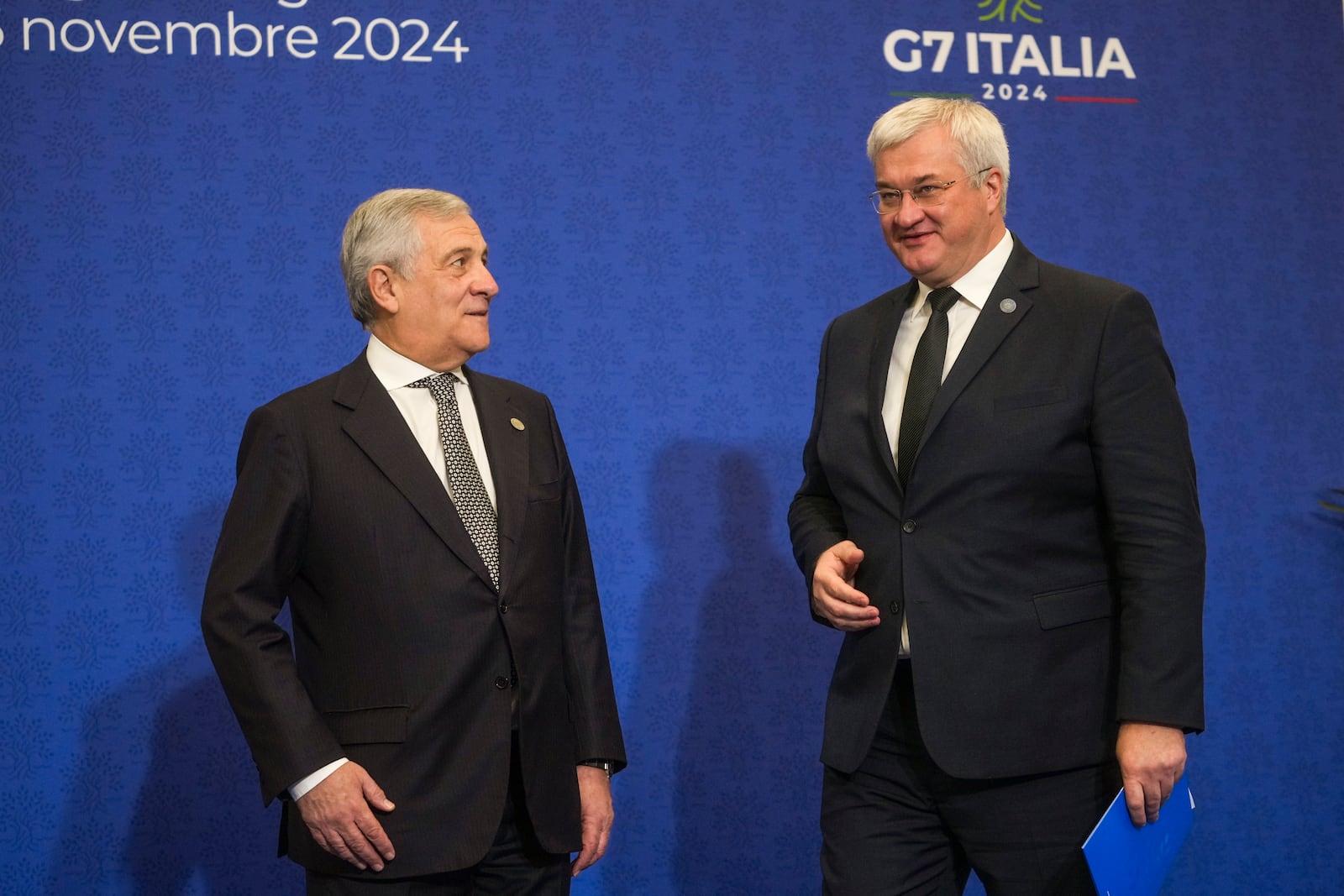 Italian Foreign Minister Antonio Tajani, left, welcomes Ukrainian Foreign Minister Andrii Sybiha for a family photo at the G7 of foreign Ministers in Fiuggi, some 70 kilometers south-east of Rome, Tuesday, Nov. 26, 2024. (AP Photo/Alessandra Tarantino, Pool)