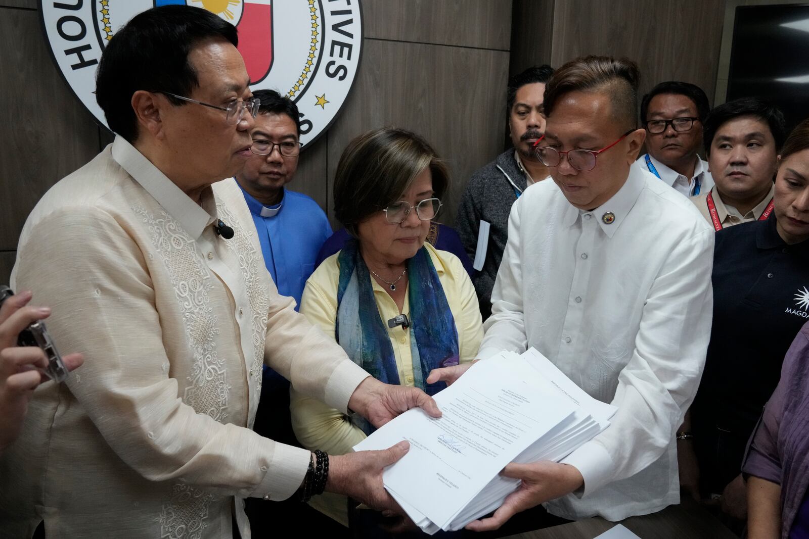 House Secretary General, Reginald Velasco, left, receives an impeachment complaint filed Monday, Dec. 2, 2024 against Philippine Vice President Sara Duterte by several prominent opponents and activists, including former Senator Leila de Lima, center, and Akbayan Partylist Representative Perci Cendana, right, at the House of Representatives in Quezon City, Philippines. (AP Photo/Aaron Favila)