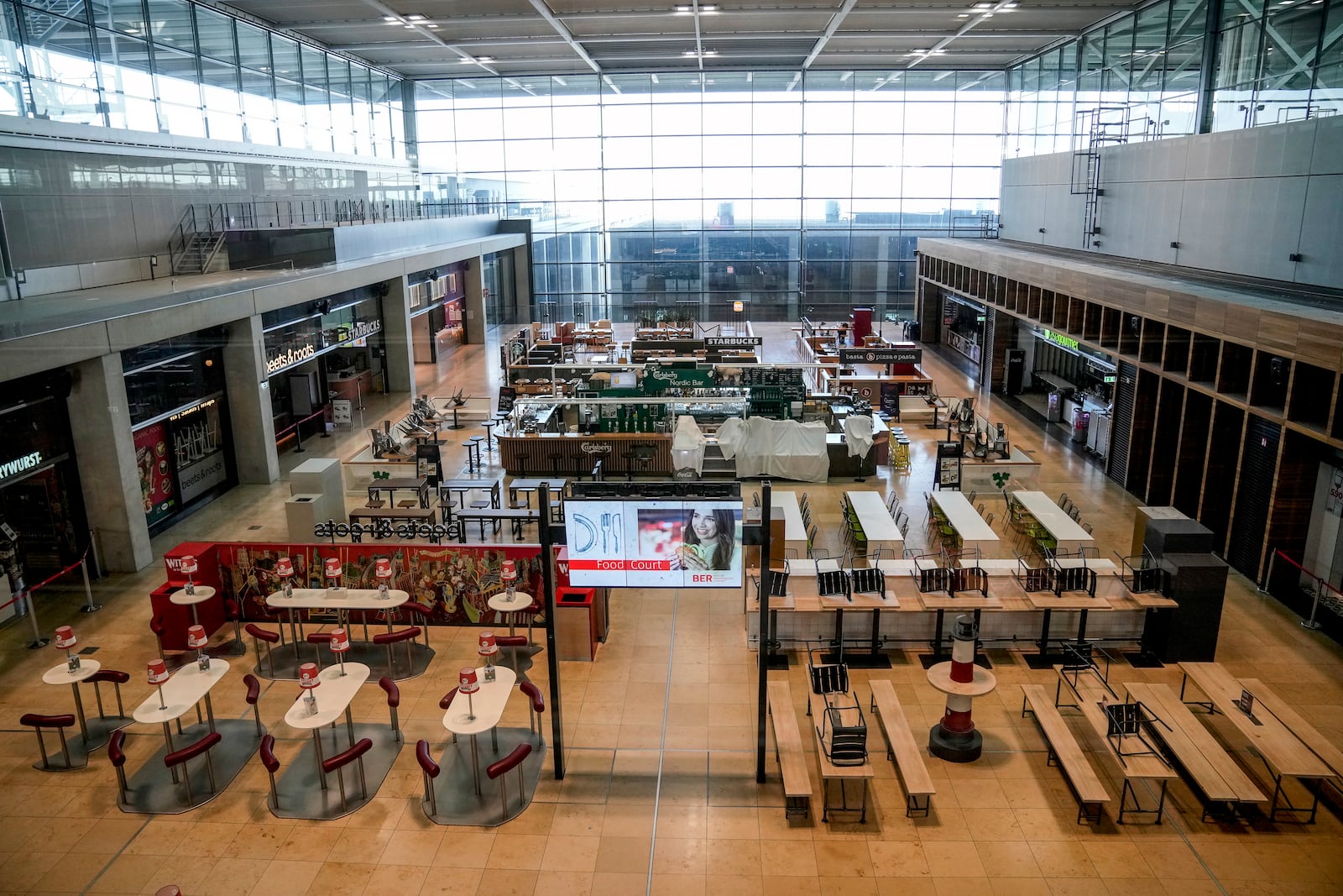 A terminal of the Berlin-Brandenburg airport is empty during the airports warning strike, Germany, Monday, March 10, 2025. (AP Photo/Ebrahim Noroozi)