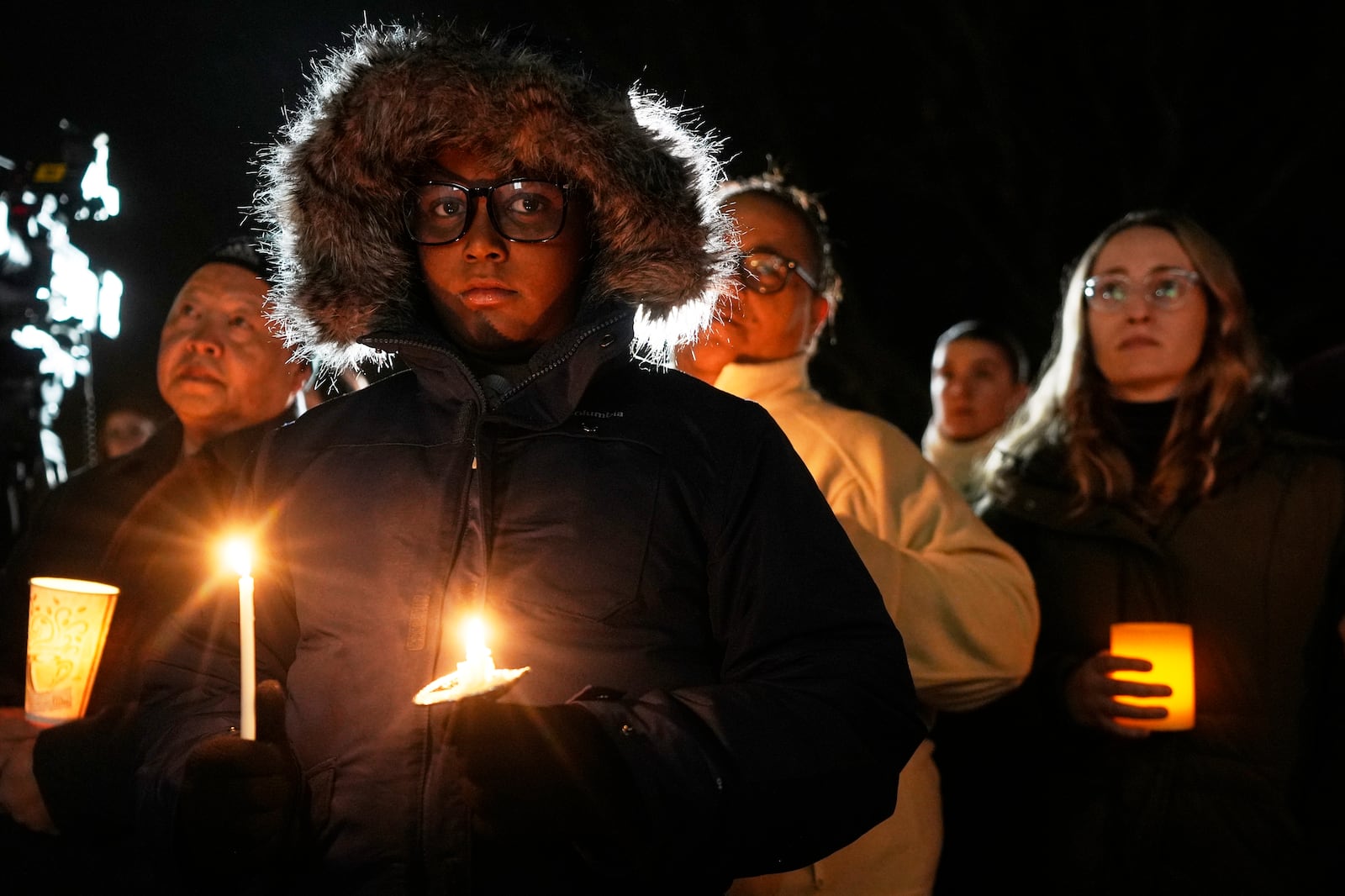 Supporters hold candles during a candlelight vigil Tuesday, Dec. 17, 2024, outside the Wisconsin Capitol in Madison, Wis., following a shooting at the Abundant Life Christian School on Monday, Dec. 16. (AP Photo/Morry Gash)