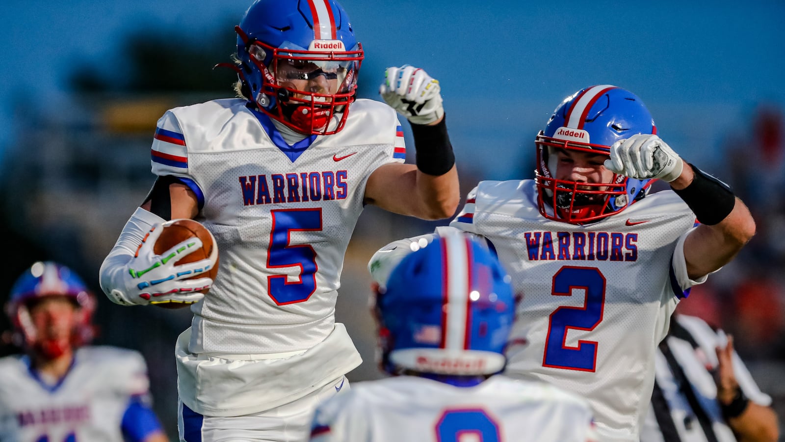 Northwestern sophomore Rennen Smith (5) celebrates with senior Miles Estes (2) after scoring a touchdown during their game against Kenton Ridge on Friday, Sept. 13 at Richard L. Phillips Field in Springfield. The Cougars won 27-21 in double overtime. Michael Cooper/CONTRIBUTED