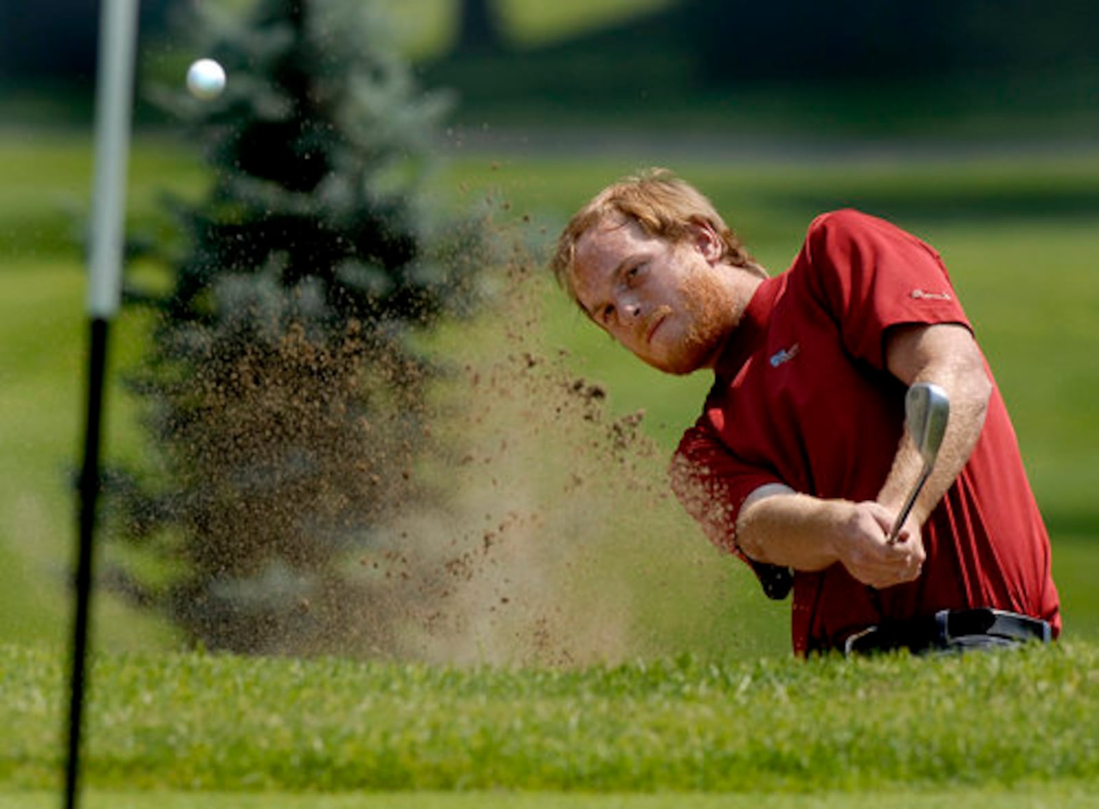 Zach Fowler hits out of sand trap during the third round of the Springfield News-Sun/National Trail Parks and Recreation Men's City Amateur golf tournament Saturday, July 19.