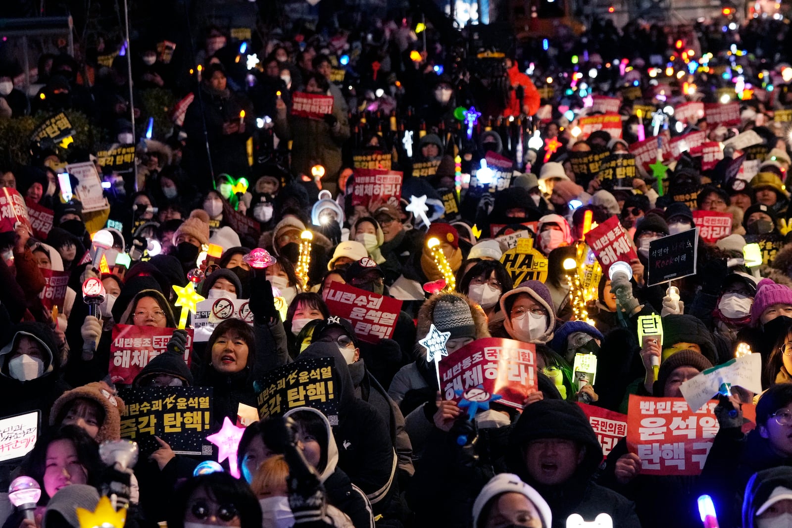 Participants stage a rally, to demand South Korean President Yoon Suk Yeol's impeachment, outside the National Assembly in Seoul, South Korea, Friday, Dec. 13, 2024. (AP Photo/Ahnn Young-joon)