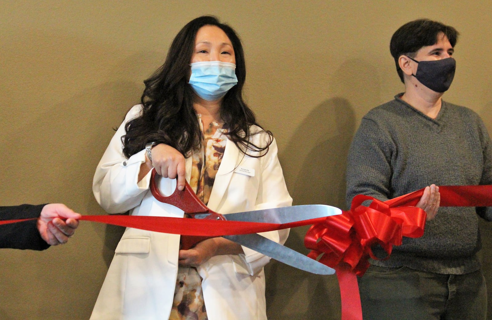 The General Manager of the Cobblestone Hotel Amanda Trainer participates in a ribbon cutting ceremony in Urbana. The hotel has been open since June, but the coronavirus pandemic delayed the official grand opening celebration. Hasan Karim/Staff