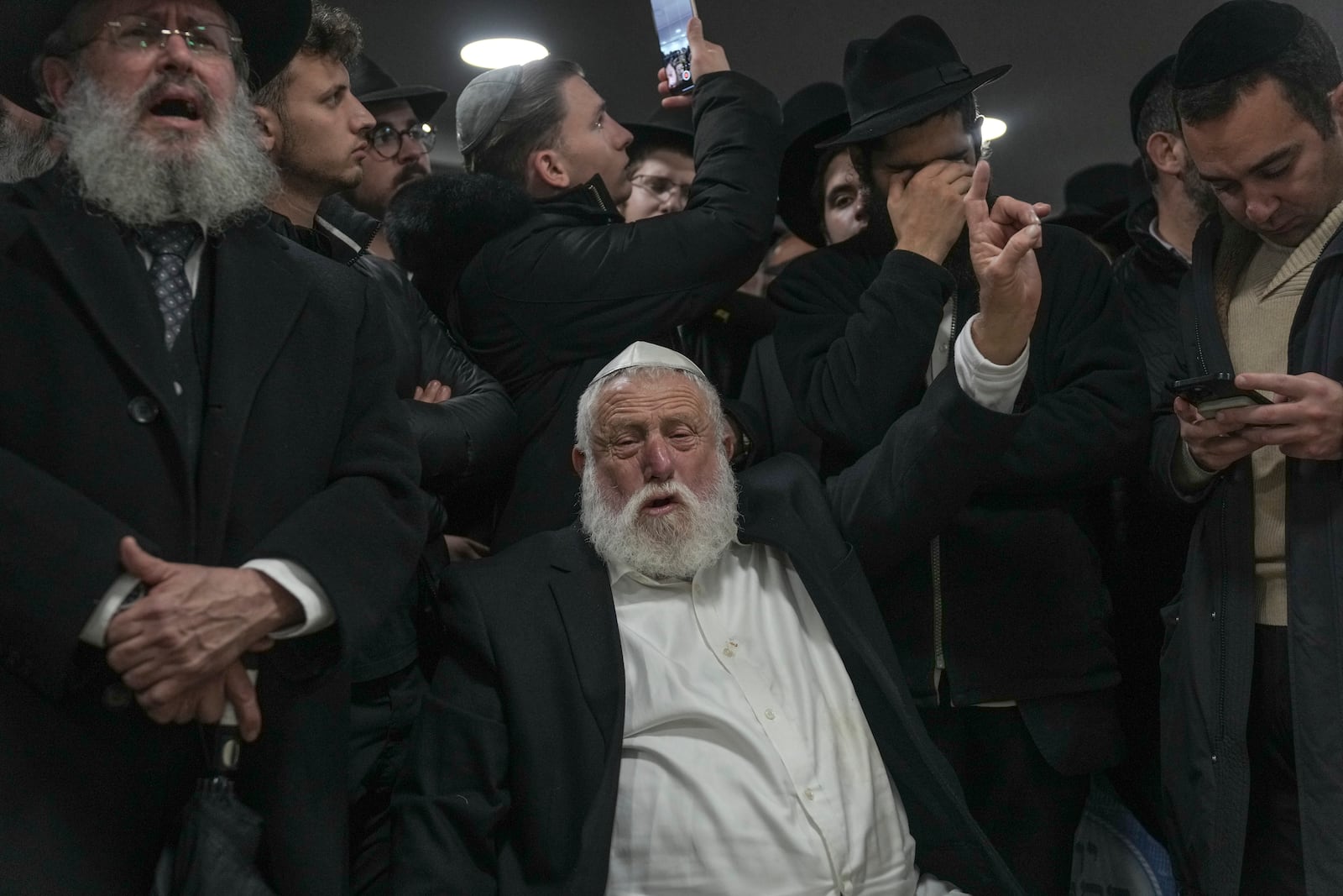 Ultra-Orthodox Jews attend the funeral of Israeli-Moldovan rabbi Zvi Kogan in Jerusalem, Monday Nov. 25, 2024. Kogan, 28, an ultra-Orthodox rabbi, was killed last week in Dubai where he ran a kosher grocery store. Israelis have flocked for commerce and tourism since the two countries forged diplomatic ties in the 2020 Abraham Accords.(AP Photo/Mahmoud Illean)