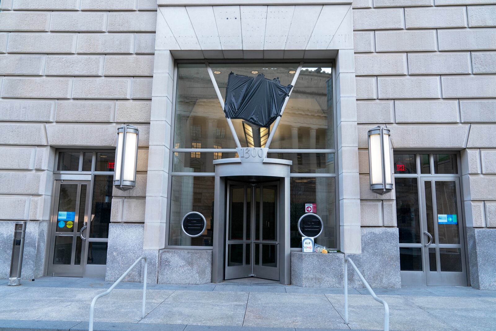 The door of the U.S. Agency for International Development, or USAID, is seen with the sign and logo removed from the wall outside of the agency's headquarters in Washington, Friday, Feb. 7, 2025. (AP Photo/Jose Luis Magana)