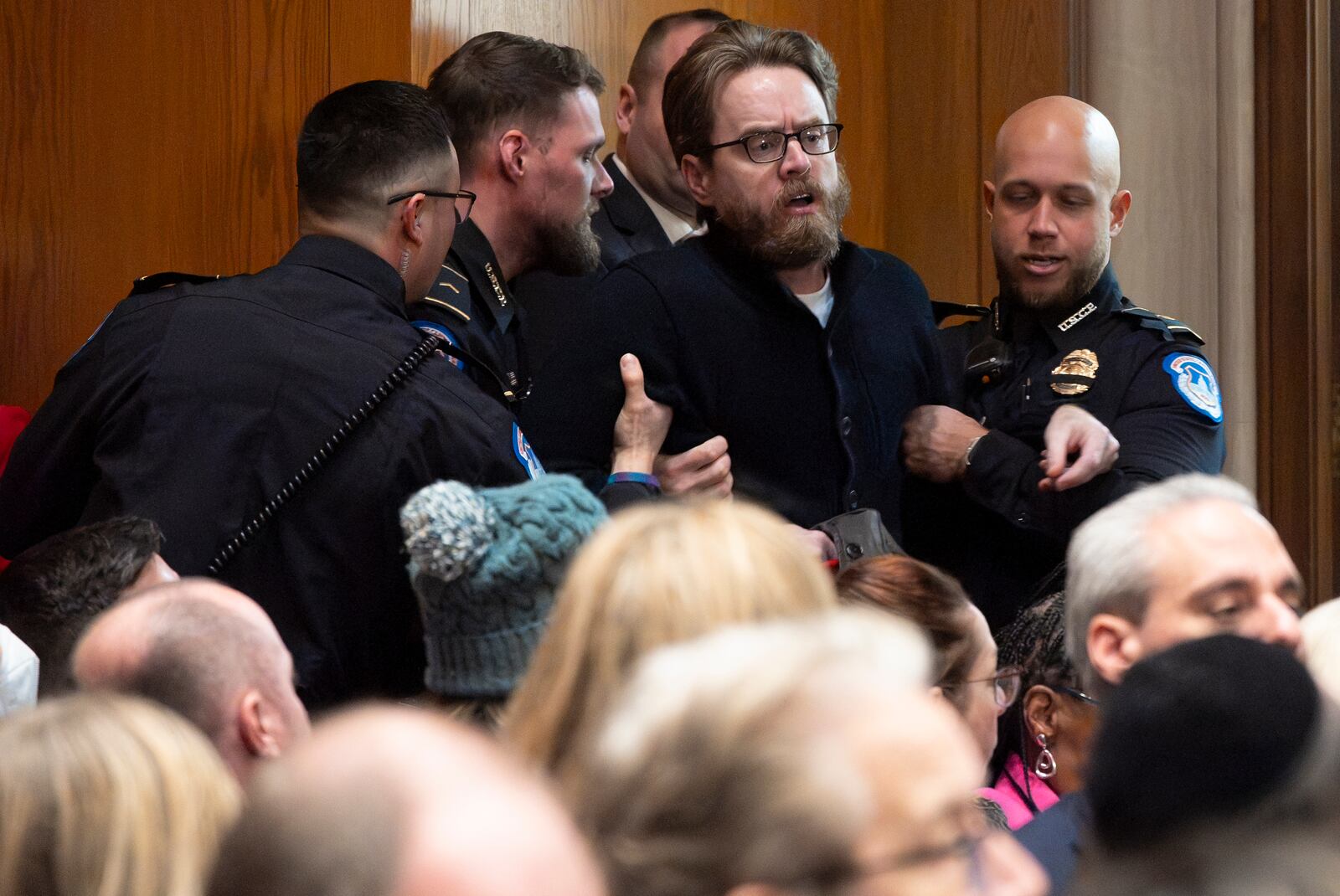 A protester saying he is a teacher is removed while calling out against the nomination of Linda McMahon, President Donald Trump's nominee for Secretary of Education, during a Senate Health, Education, and Labor Committee hearing on McMahon's nomination, Thursday, Feb. 13, 2025, in Washington. (AP Photo/Jacquelyn Martin)