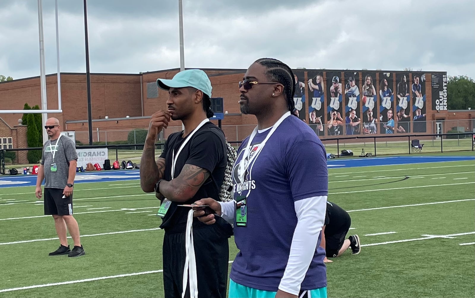 Braxton Miller and Troy Smith watch Jim Tressel speak at their football camp in Urbana on July 9, 2021.