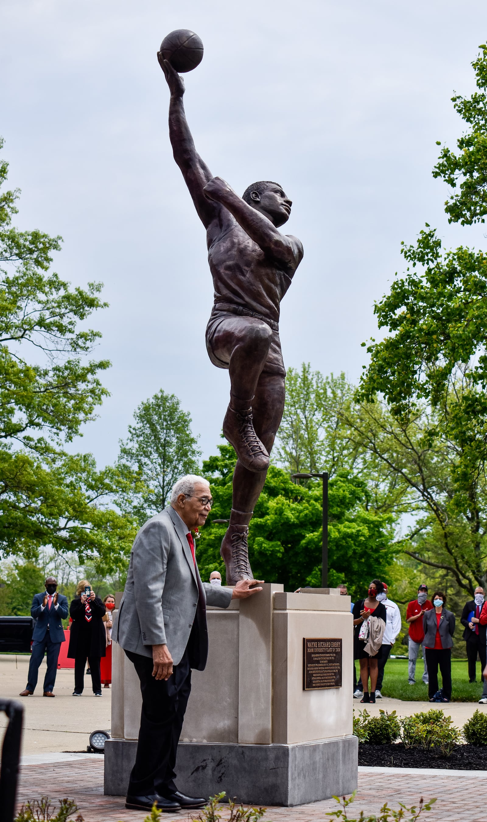 Wayne Embry stands during statue is unveiled in his honor Tuesday, May 18, 2021 at Miami University in Oxford. Wayne Embry and his late wife Theresa Embry, both Miami alumni, were awarded the Freedom of Summer of '64 Award for their life's work as civil right champions and mentors. A statue of Wayne Embry in a basketball pose, created by sculptor Tom Tsuchiya, was unveiled in front of Millett Hall and a scholarship in his name was announced to support Miami varsity men's basketball student athletes. NICK GRAHAM / STAFF