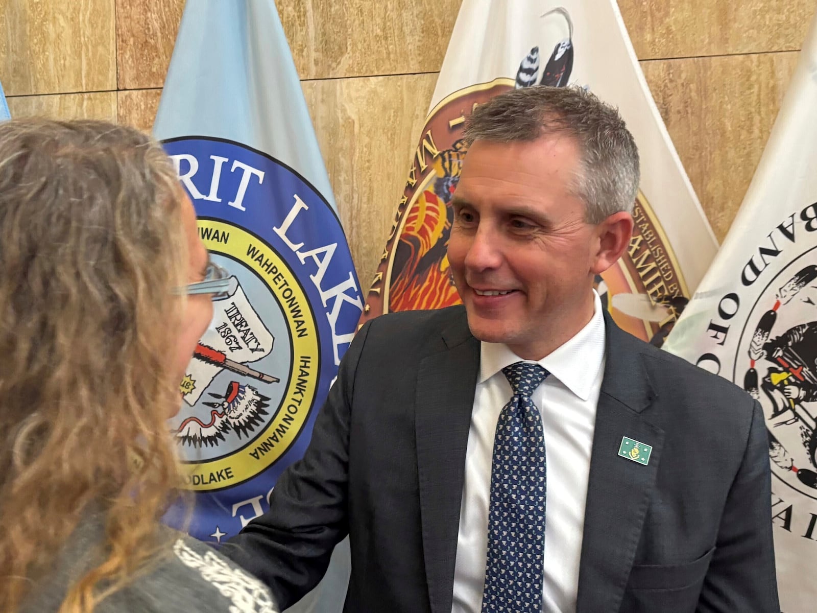 FILE - North Dakota Republican Gov. Kelly Armstrong, at right, greets state Rep. Dori Hauck in a receiving line following his State of the State address on Jan. 7, 2025, at the state Capitol in Bismarck, N.D. (AP Photo/Jack Dura, file)