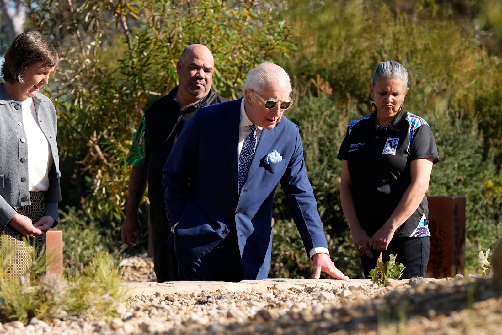 Britain's King Charles III, center, inspect plants during a visit to Australian National Botanic Gardens in Canberra, Monday, Oct. 21, 2024. (AP Photo/Mark Baker, Pool)