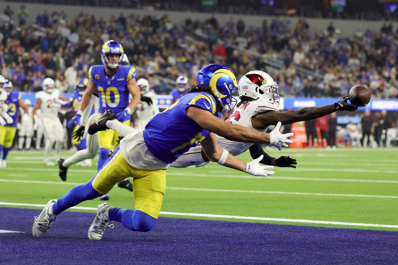 Arizona Cardinals cornerback Max Melton, right, breaks up a pass intended for Los Angeles Rams wide receiver Puka Nacua during the second half of an NFL football game Saturday, Dec. 28, 2024, in Inglewood, Calif. (AP Photo/Ryan Sun)