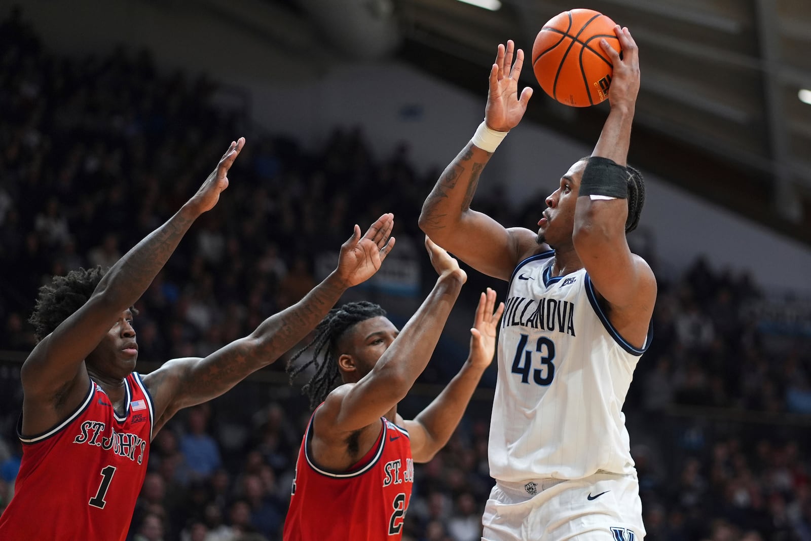 Villanova's Eric Dixon (43) goes up for a shot against St. John's Zuby Ejiofor (24) and Kadary Richmond (1) during the second half of an NCAA college basketball game, Wednesday, Feb. 12, 2025, in Villanova, Pa. (AP Photo/Matt Slocum)