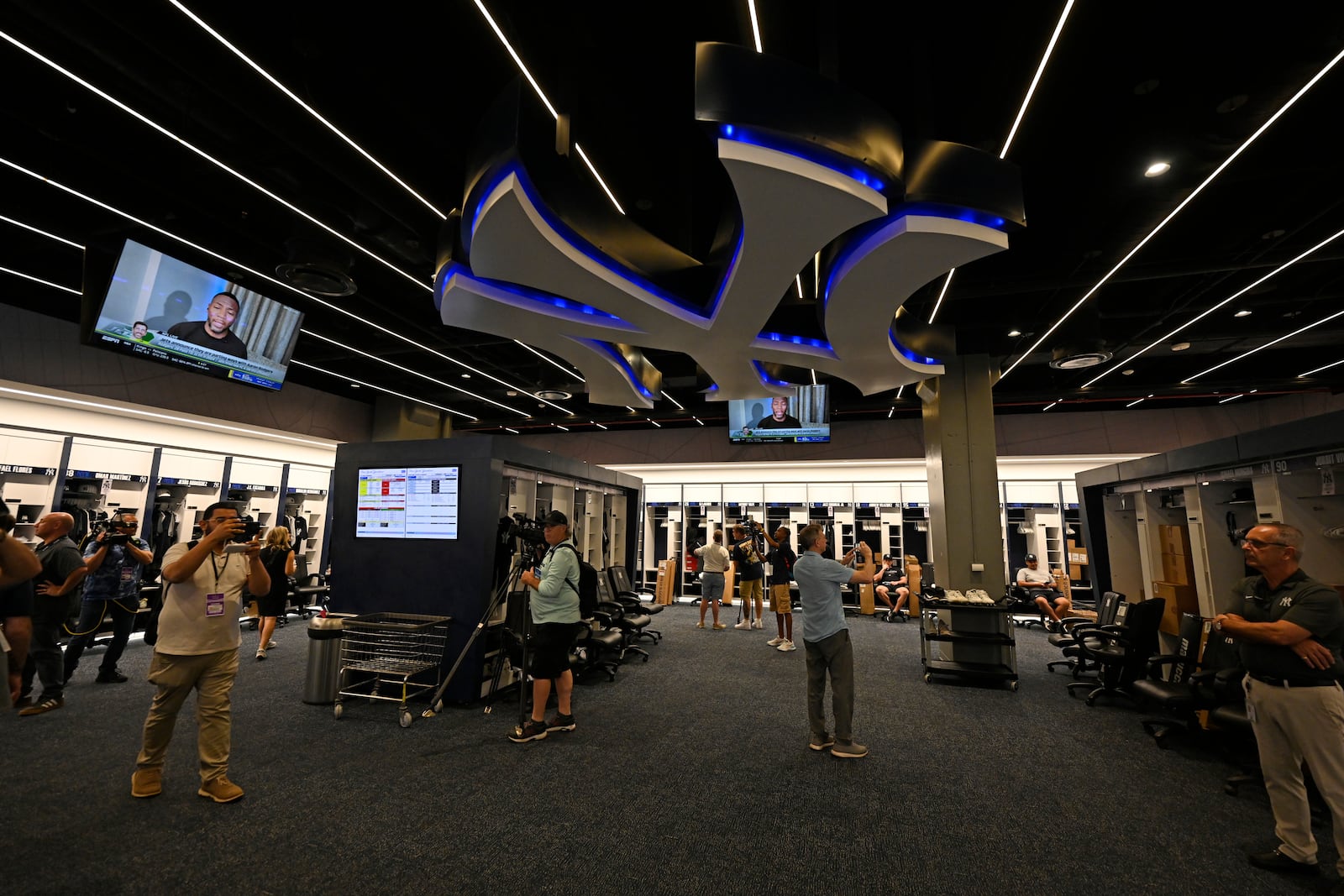 Members of the media look around the New York Yankees clubhouse during a tour of the upgraded team spring training facilities Thursday, Feb. 13, 2025, at George M. Steinbrenner Field in Tampa, Fla. (AP Photo/Steve Nesius)