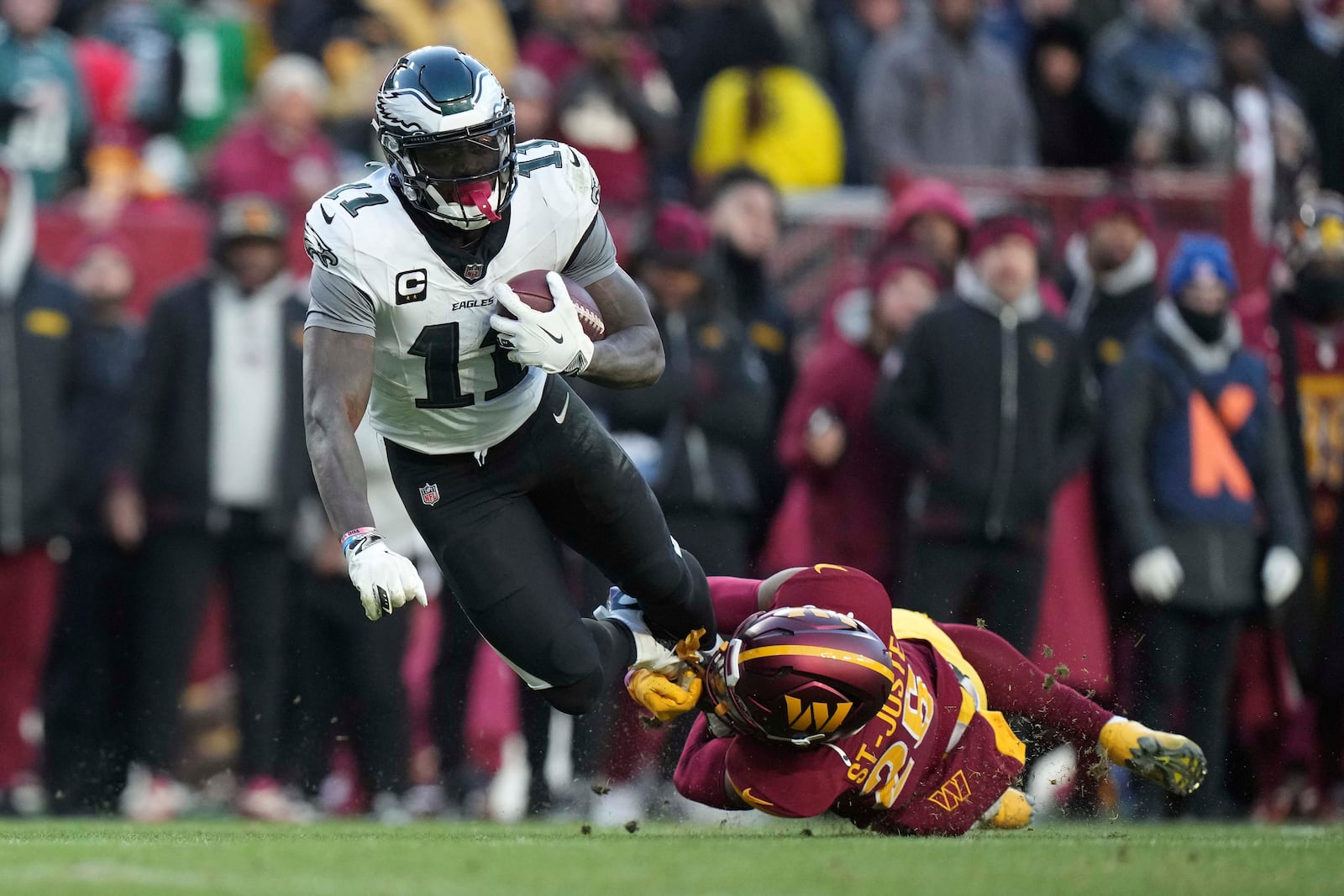 Philadelphia Eagles wide receiver A.J. Brown (11) is tackled by Washington Commanders cornerback Benjamin St-Juste (25) during the second half of an NFL football game, Sunday, Dec. 22, 2024, in Landover, Md. (AP Photo/Stephanie Scarbrough)