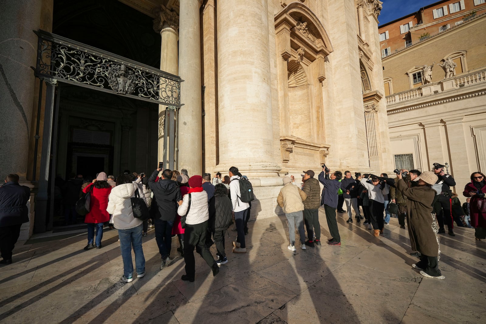 Faithful arrive to walk through the Holy Door of St.Peter's Basilica at the Vatican, Wednesday, Dec. 25, 2024, after it was opened by Pope Francis on Christmas Eve marking the start of the Catholic 2025 Jubilee. (AP Photo/Andrew Medichini)