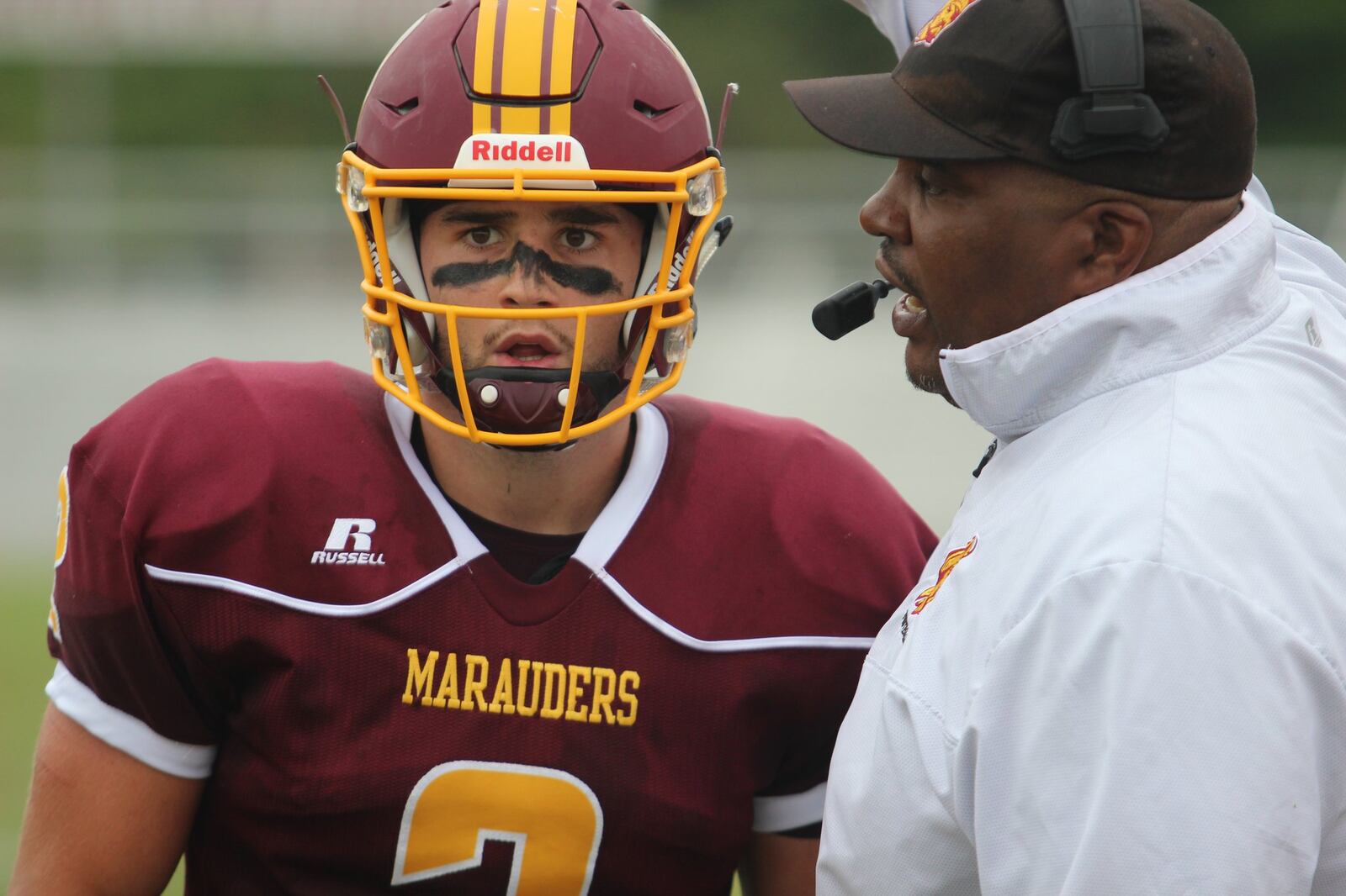 Central State quarterback Trent Mays talks to coach Cedric Pearl during Saturday’s season opener. MIKE HARTSOCK/STAFF