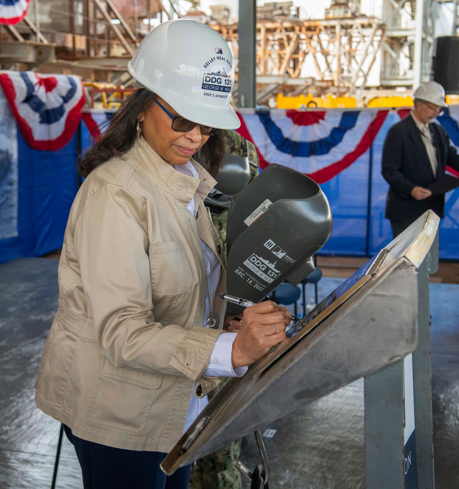 Kelley Elaine Neal Gray writes her initials on the keel of the battleship that will be named for her father, Springfield-born Korean War hero George M. Neal. CONTRIBUTED