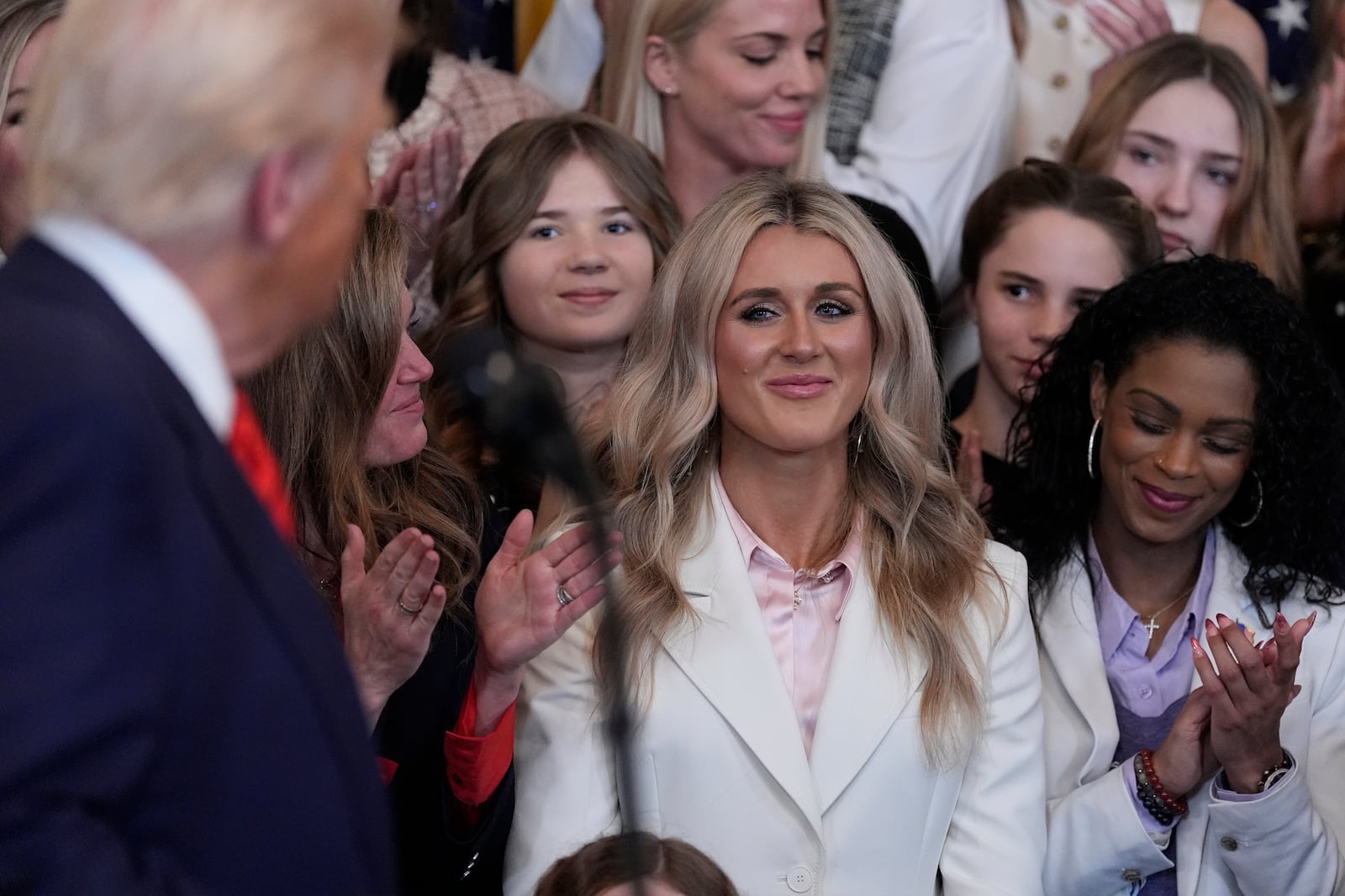 President Donald Trump acknowledges Riley Gaines as he speaks before signing an executive order barring transgender female athletes from competing in women's or girls' sporting events, in the East Room of the White House, Wednesday, Feb. 5, 2025, in Washington. (AP Photo/Alex Brandon)