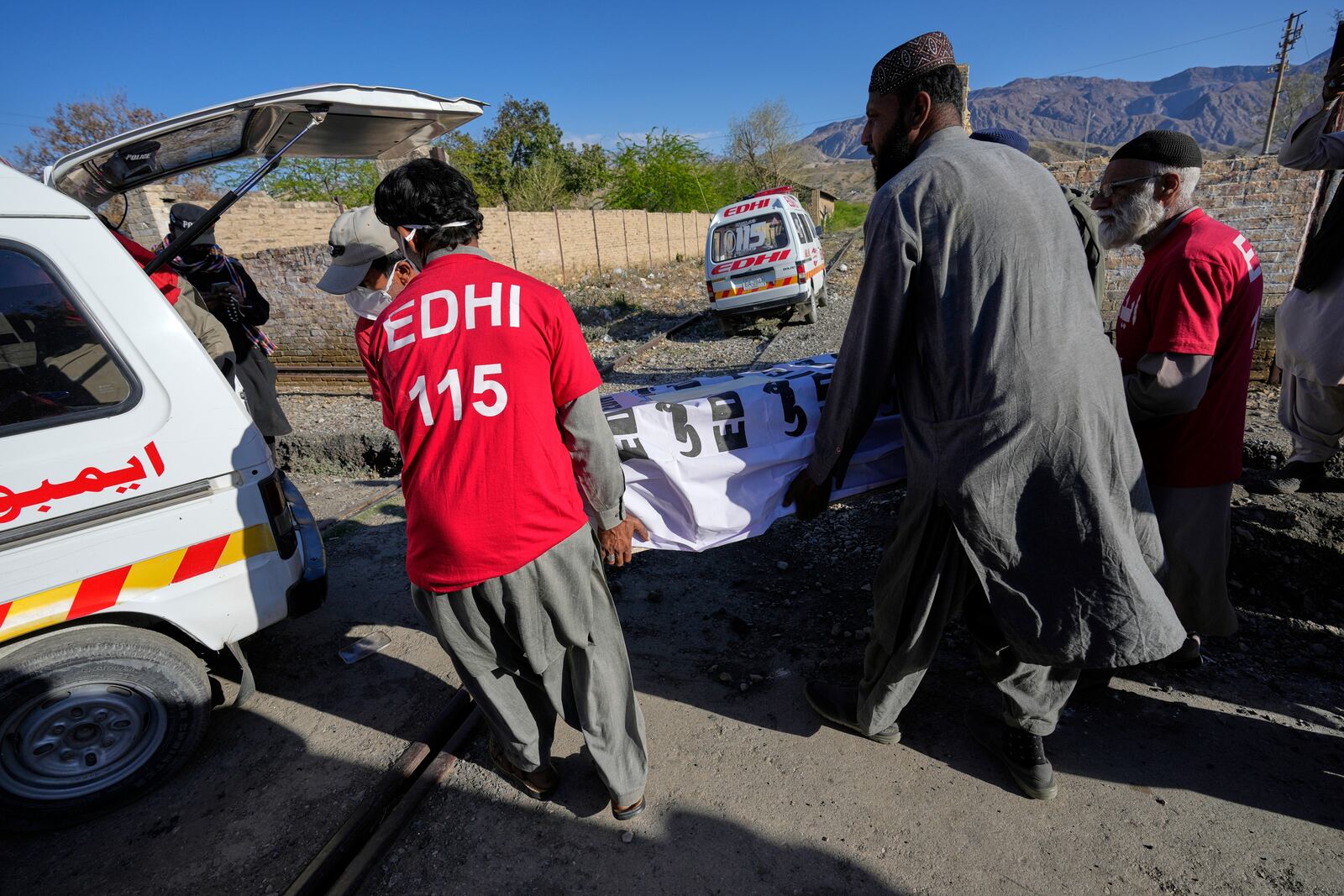 Rescue workers transport a coffin containing the body of a victim from a passenger train attacked by insurgents, upon arrival at a railway station in Much, Pakistan's southwestern Balochistan province, Thursday March 13, 2025. (AP Photo/Anjum Naveed)