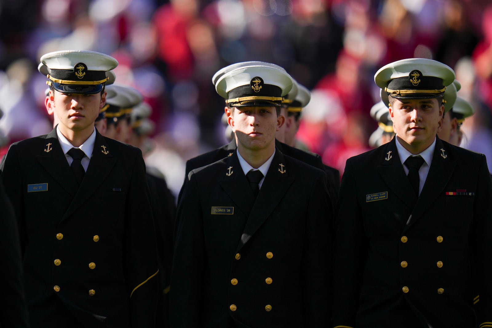 U.S. Navy Midshipmen march on the field prior to the Armed Forces Bowl NCAA college football game between Navy and Oklahoma, Friday, Dec. 27, 2024, in Fort Worth, Texas. (AP Photo/Julio Cortez)