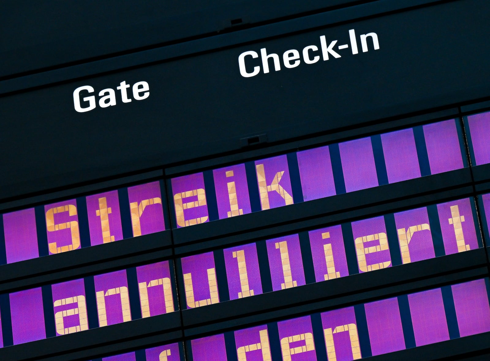 The words "strike" and "canceled" are written on a display board in Terminal 2 at Munich Airport, Germany Monday, March 10, 2025. (Peter Kneffel/dpa/dpa via AP)