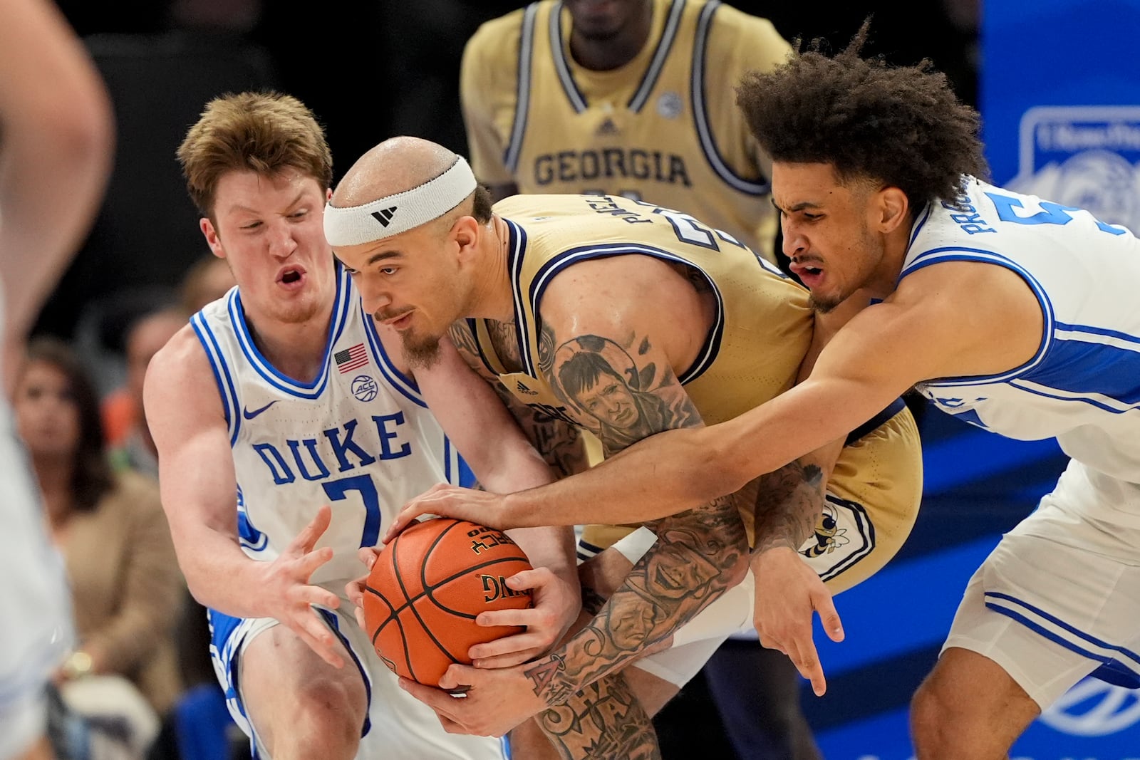 Georgia Tech forward Duncan Powell vies for the ball between Duke guard Kon Knueppel, left, and guard Tyrese Proctor during the first half of an college basketball game in the quarterfinals of the Atlantic Coast Conference tournament, Thursday, March 13, 2025, in Charlotte, N.C. (AP Photo/Chris Carlson)