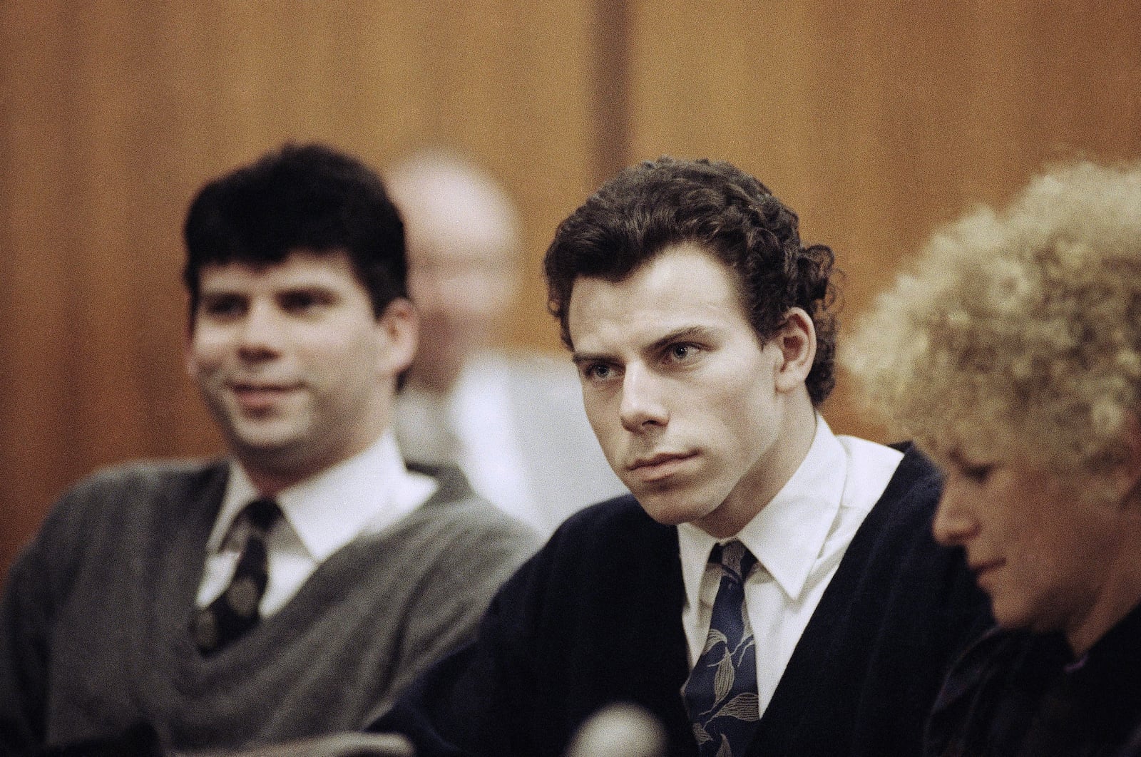 FILE - Lyle, left, and Erik Menendez sit with defense attorney Leslie Abramson, right, in the Municipal Court in the Beverly Hills area of Los Angeles, during a hearing, Nov. 26, 1990. (AP Photo/Nick Ut, File)